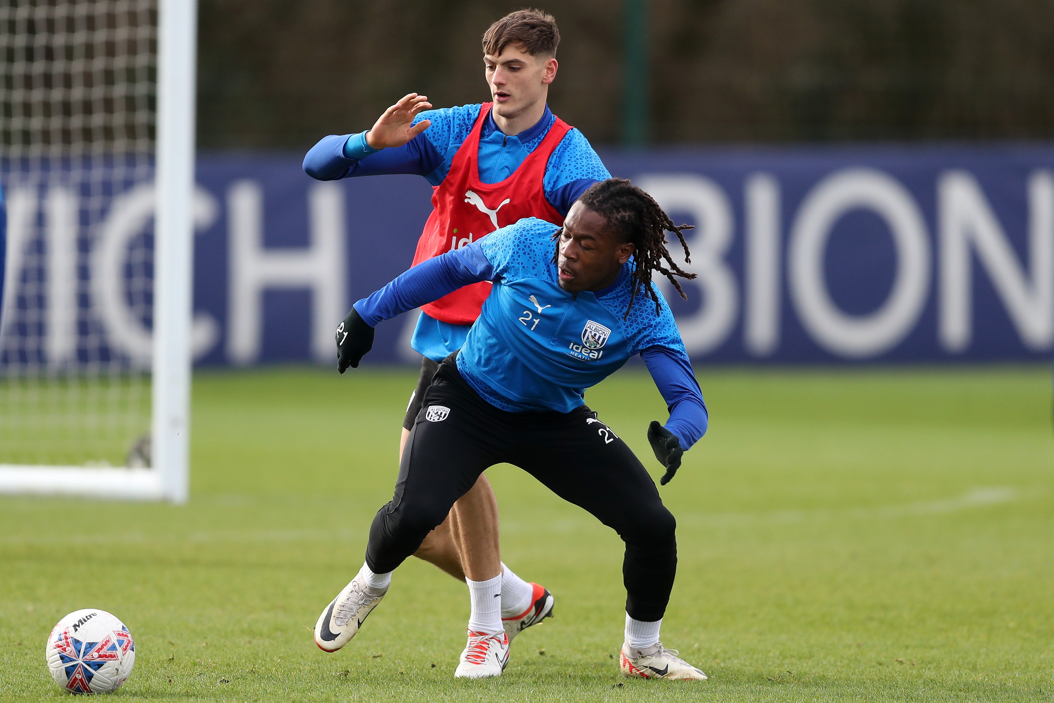 Brandon Thomas-Asante and Caleb Taylor fight for the ball in training 