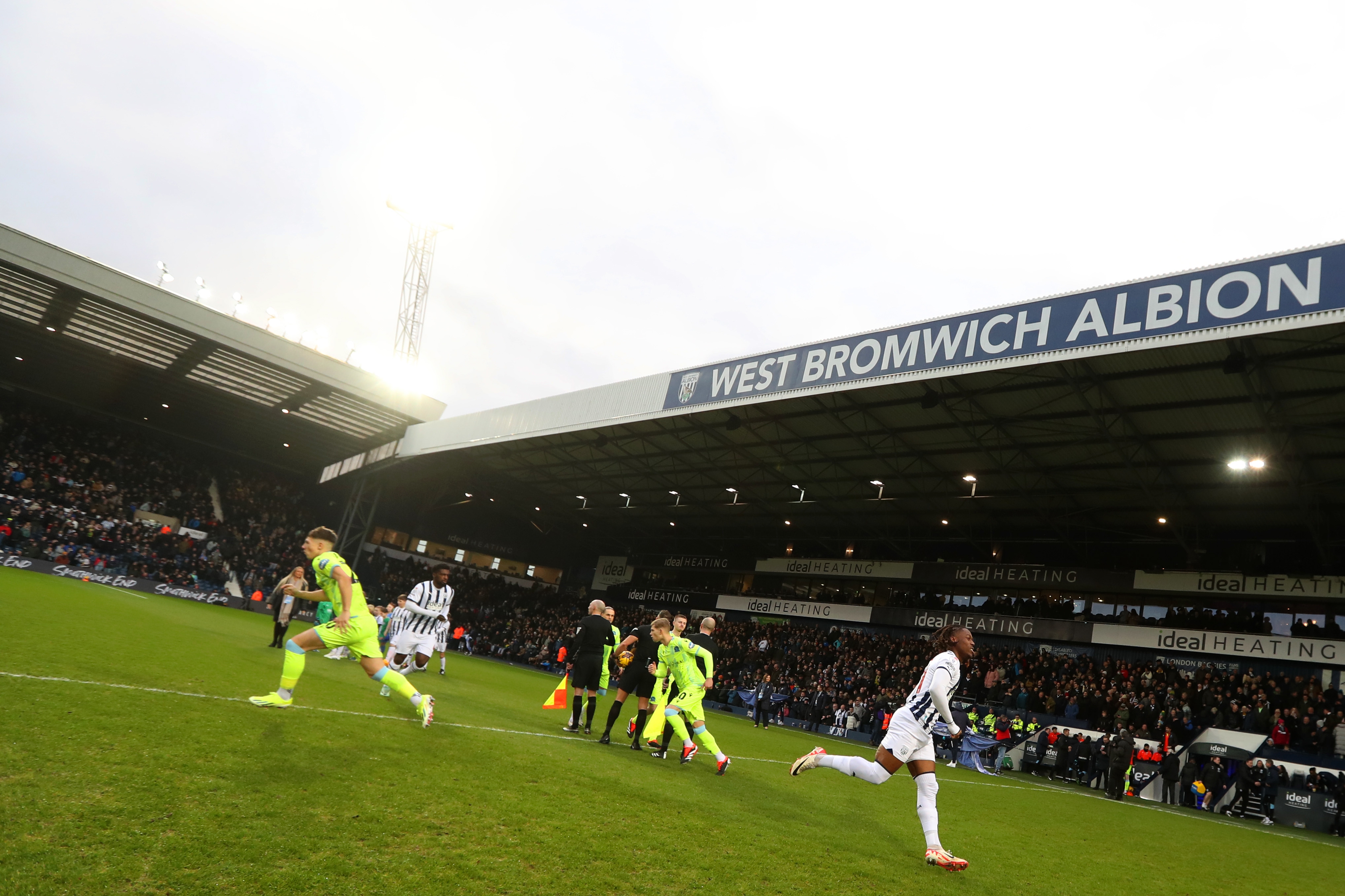 Albion players and Blackburn players break away from the line up before kick-off at The Hawthorns