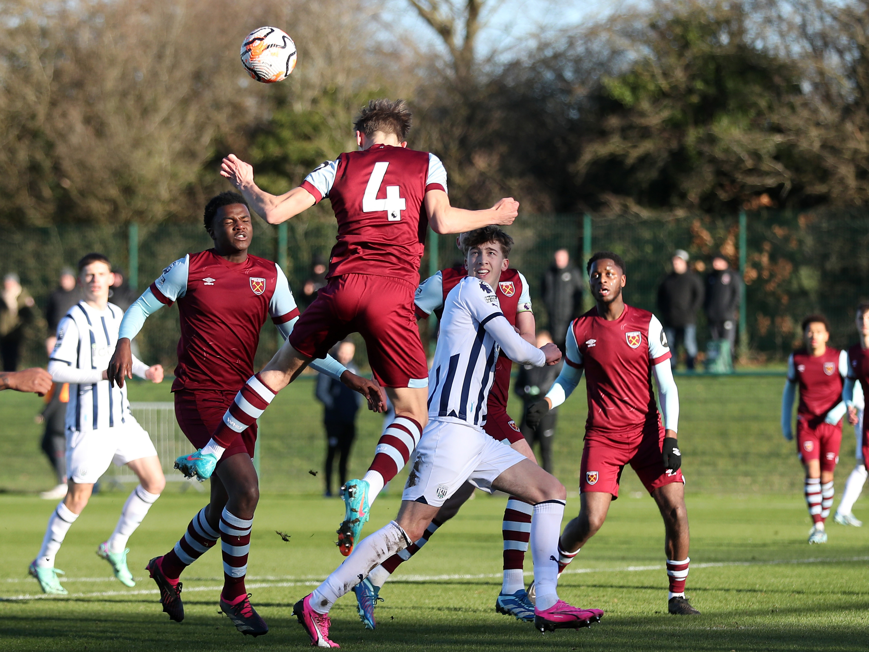 Albion players and West Ham players jump for the ball in a PL2 clash