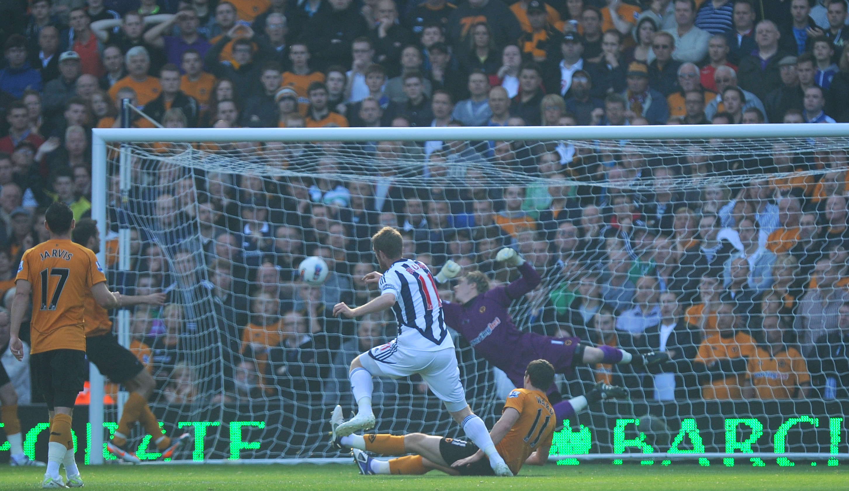 The ball hitting the back of the net as Chris Brunt scores against Wolves in 2011