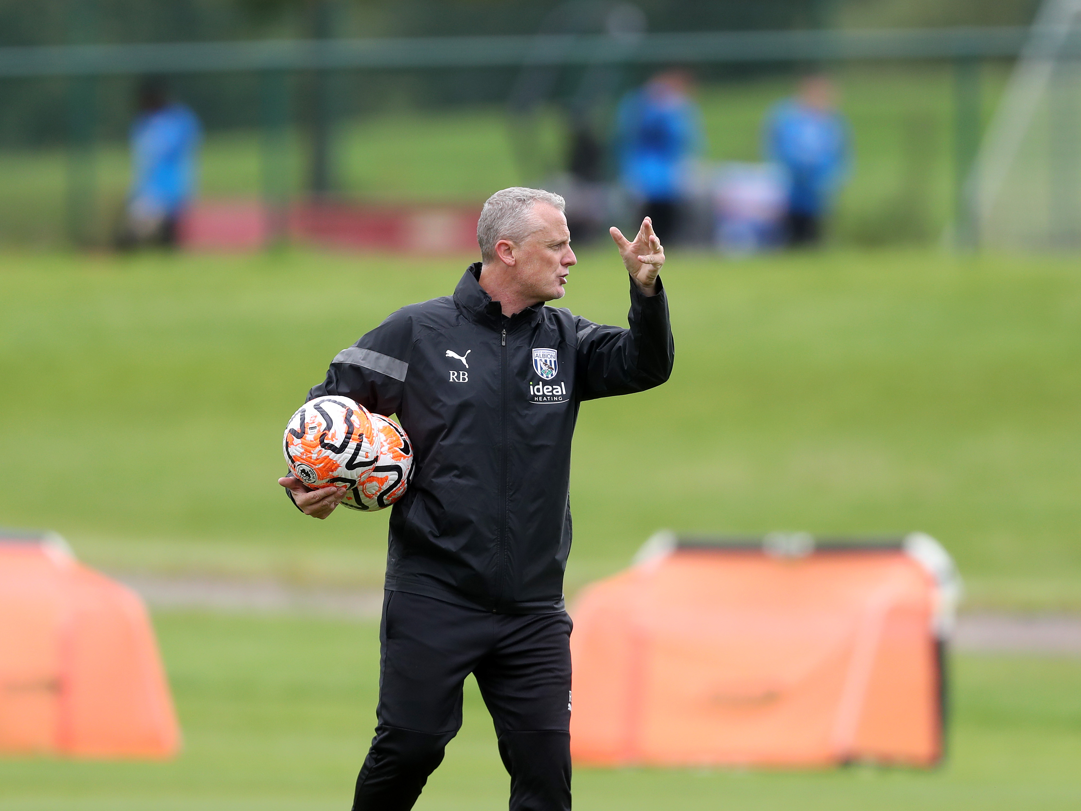 A photo of Albion PL2 boss Richard Beale handing out instructions on the training pitches at the Baggies' training ground