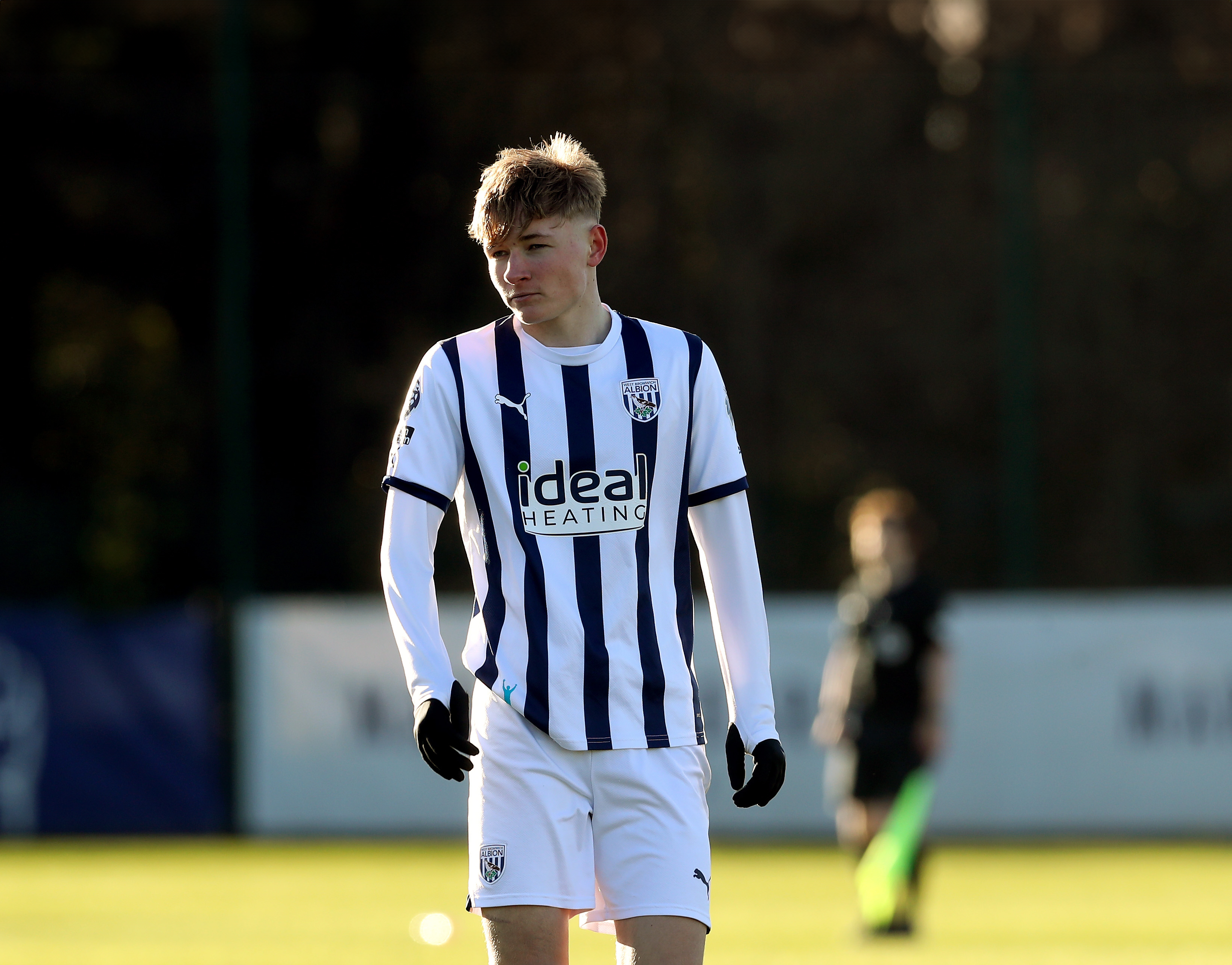 A photo of Albion U18s midfielder Ollie Bostock, wearing the 2023/24 home kit, in action at the club's training ground