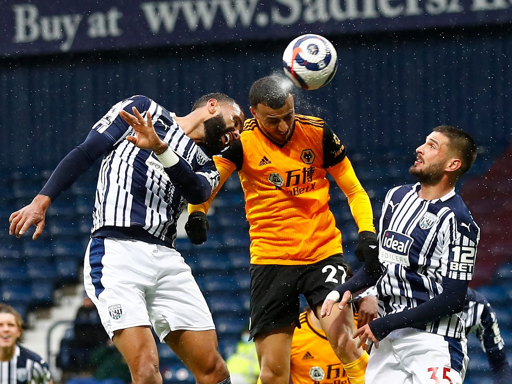 Kyle Bartley and Okay Yokuslu try and win the ball against a Wolves player