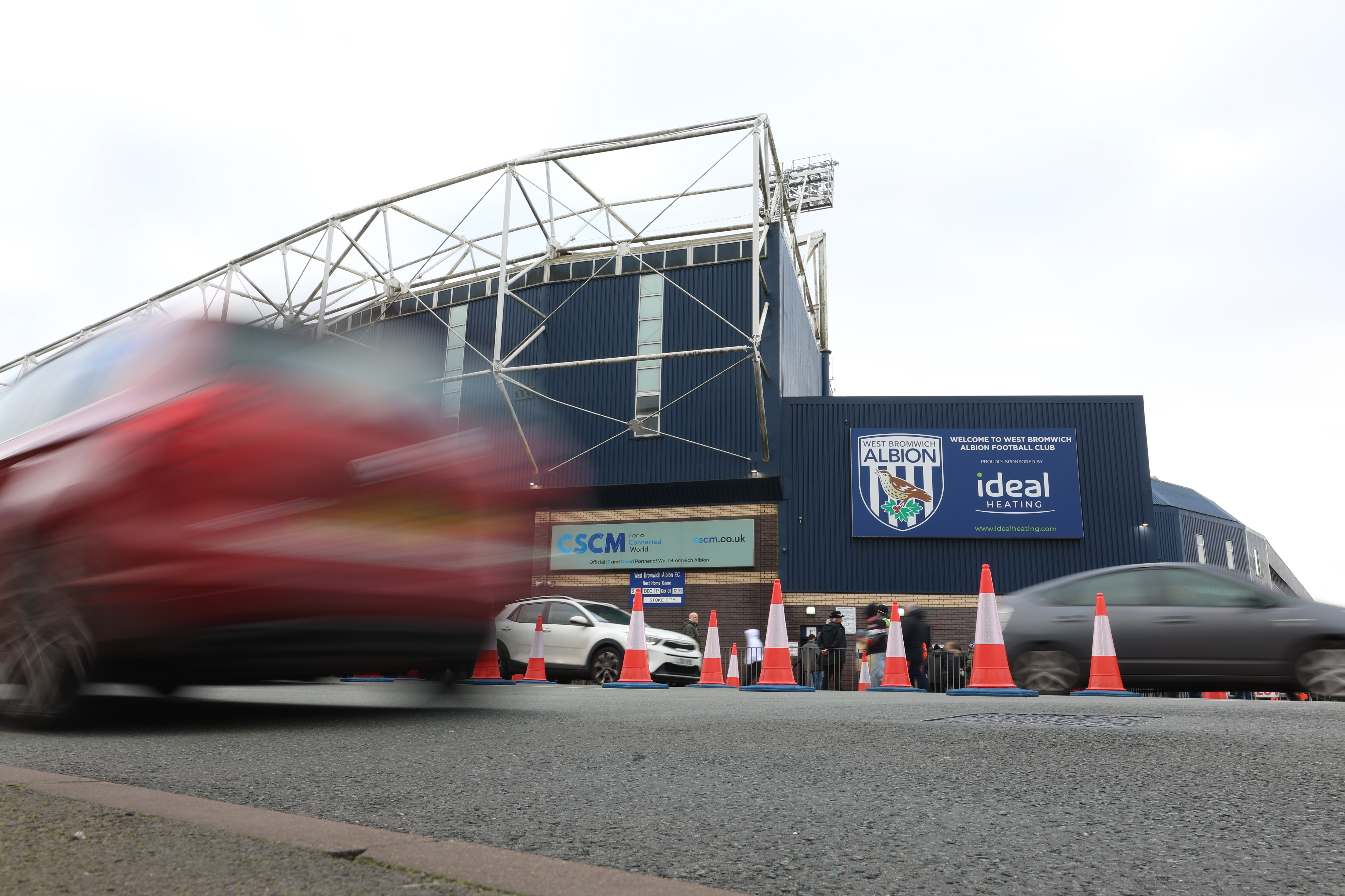 Traffic cones on the Birmingham Road with The Hawthorns in the background 