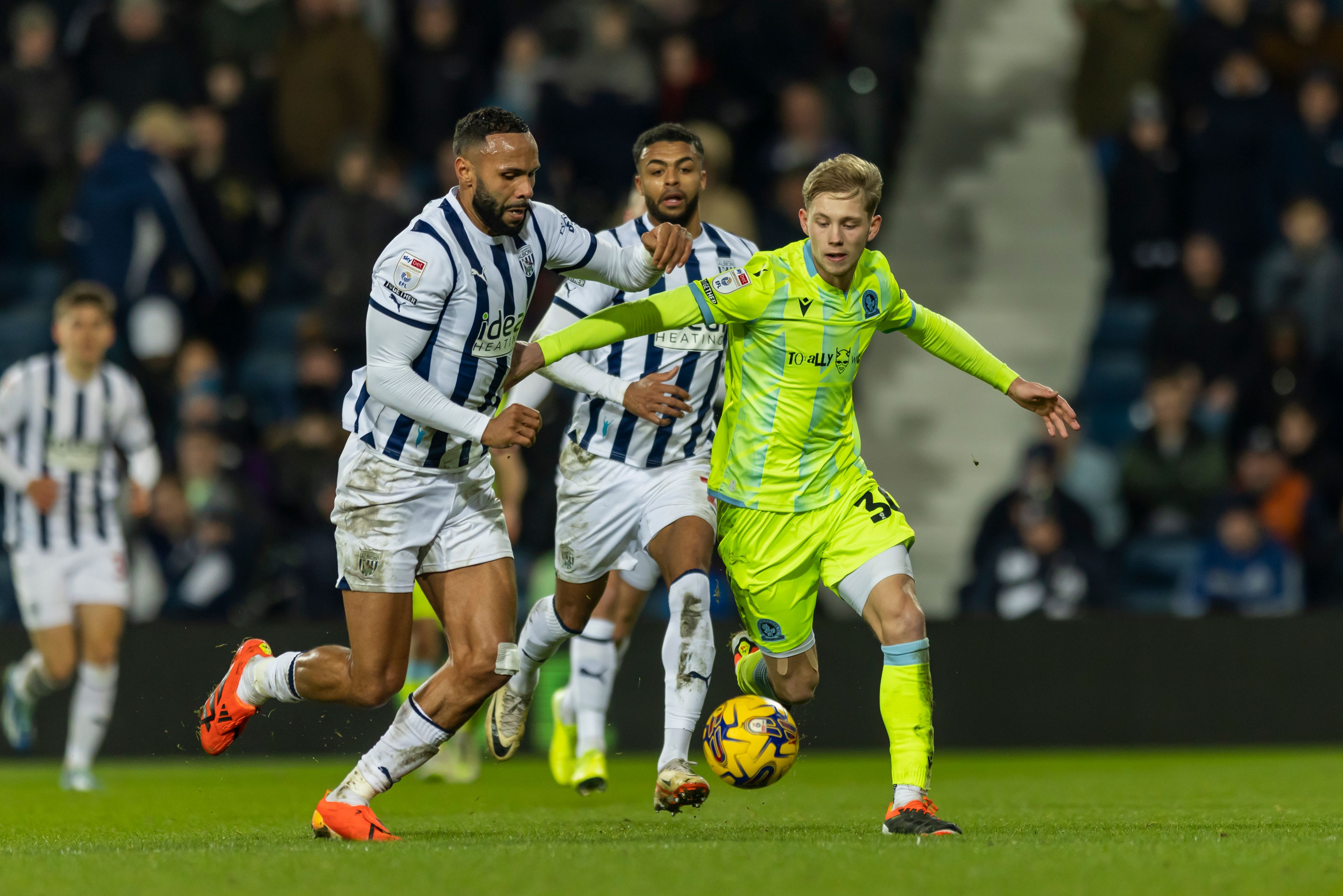 Kyle Bartley fights for the ball against a Blackburn player