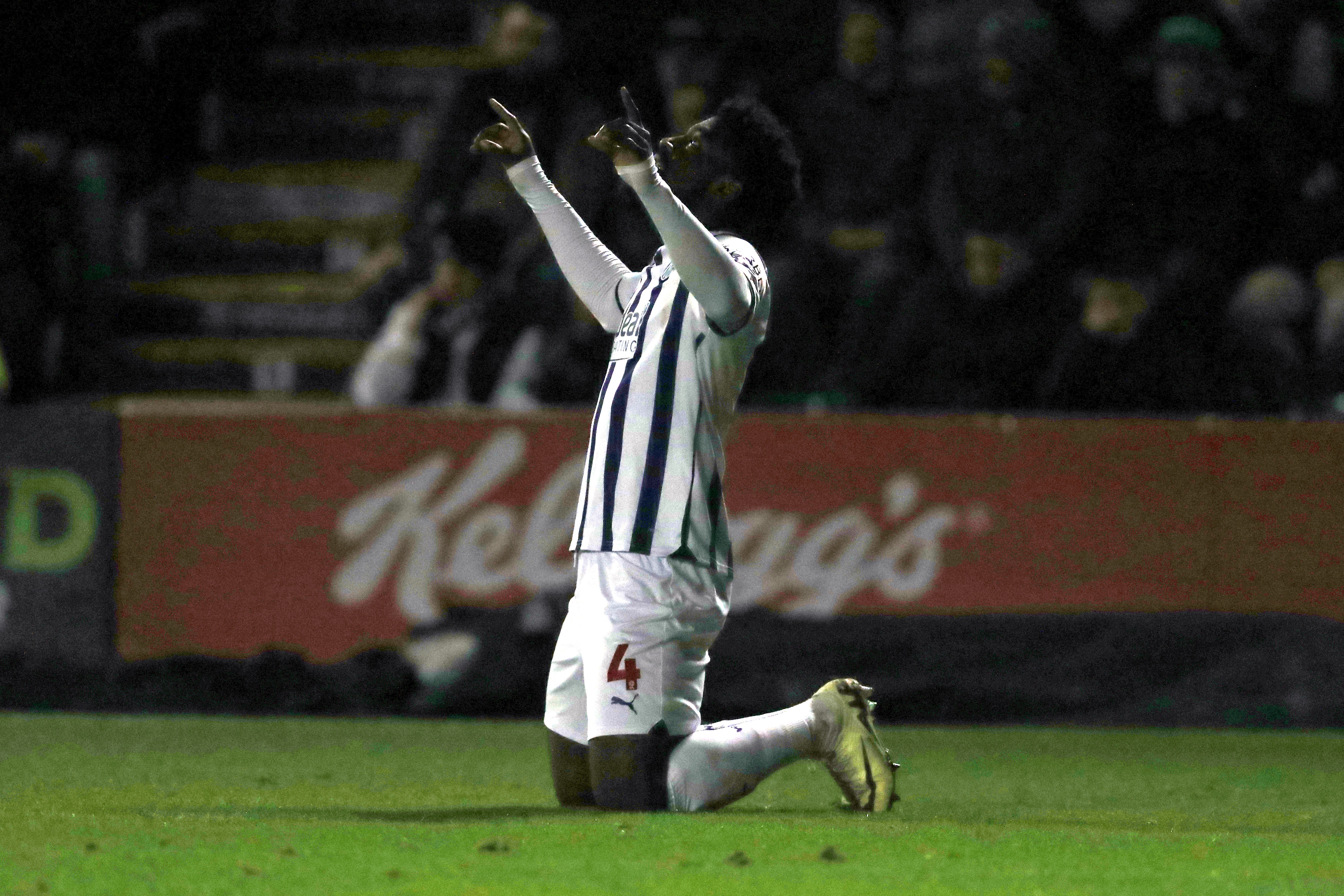 Cedric Kipre on his knees pointing at the sky with both hands after scoring against Plymouth 