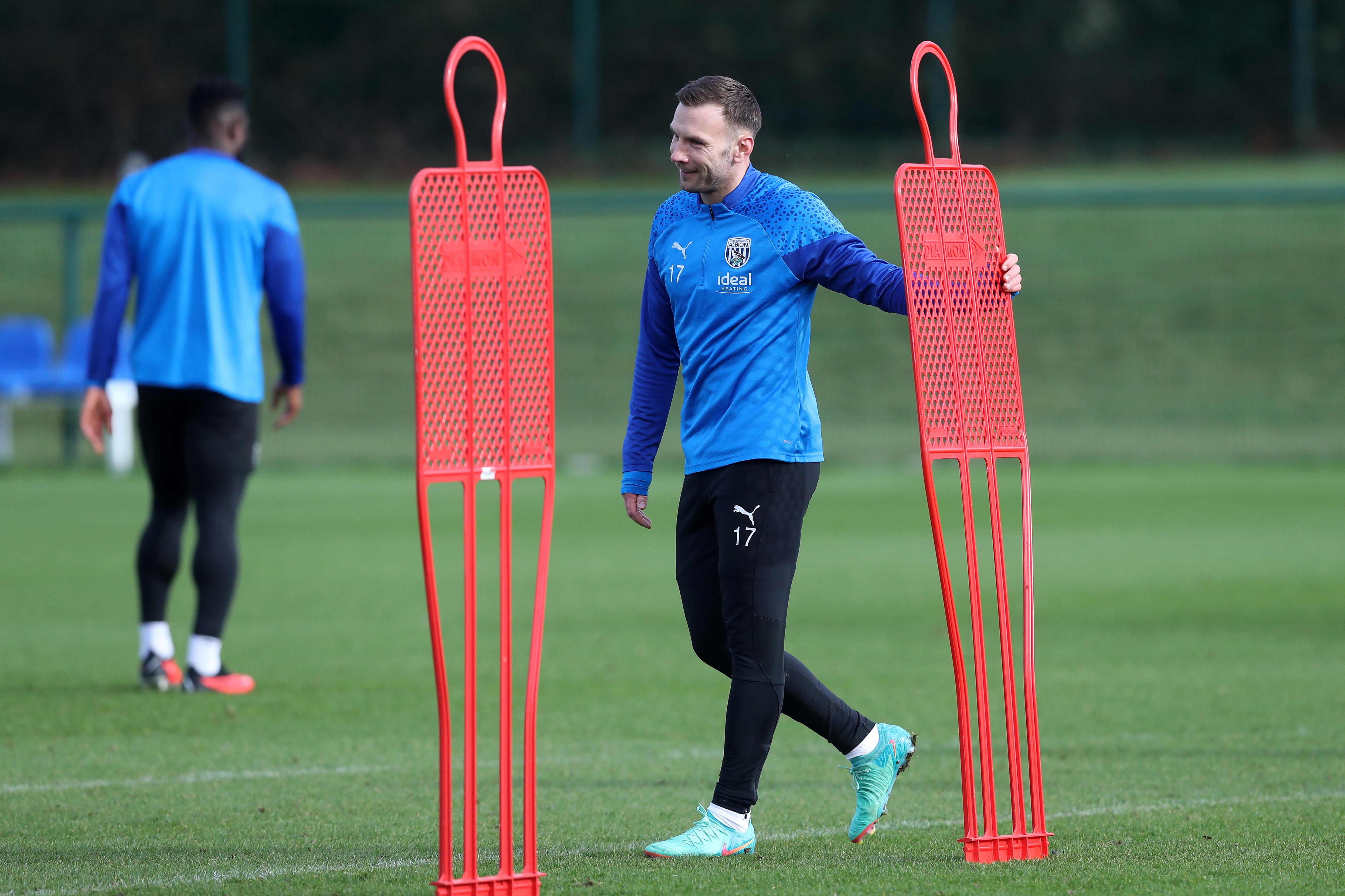 Andi Weimann holding a mannequin during a training session