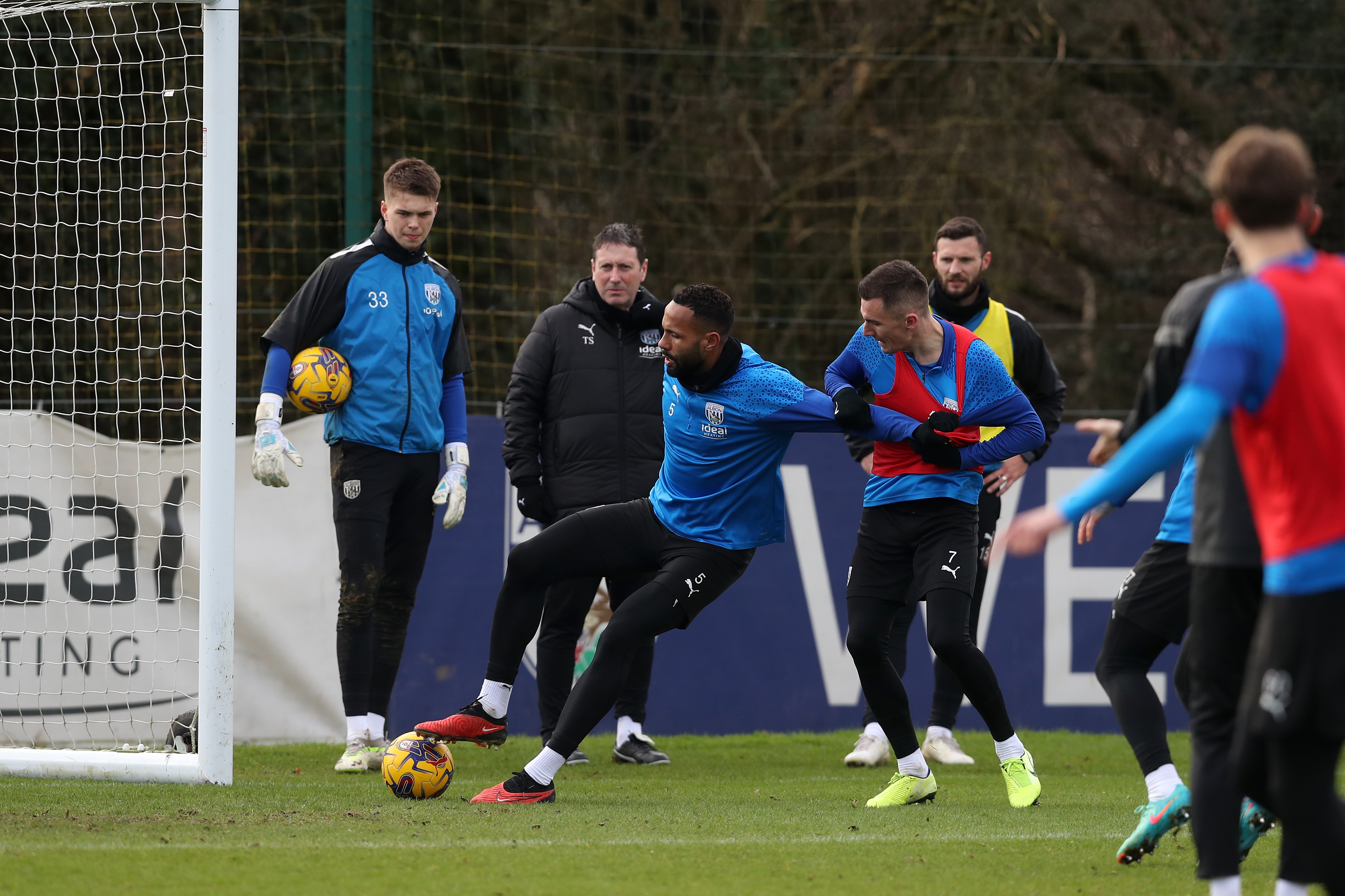 Kyle Bartley on the ball, holding off Jed Wallace during a training session