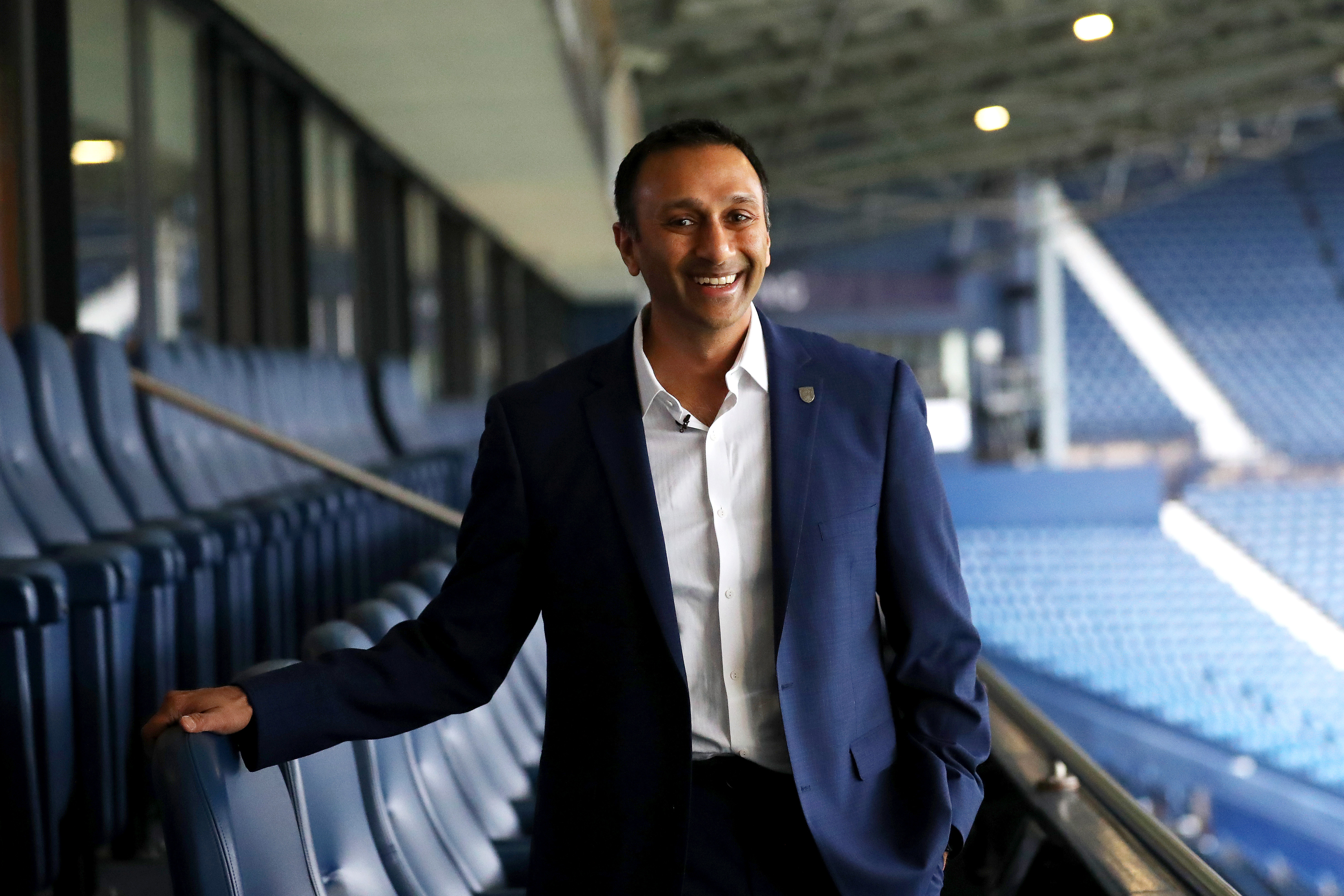 Shilen Patel stood on the balcony in the West Stand at The Hawthorns smiling at the camera