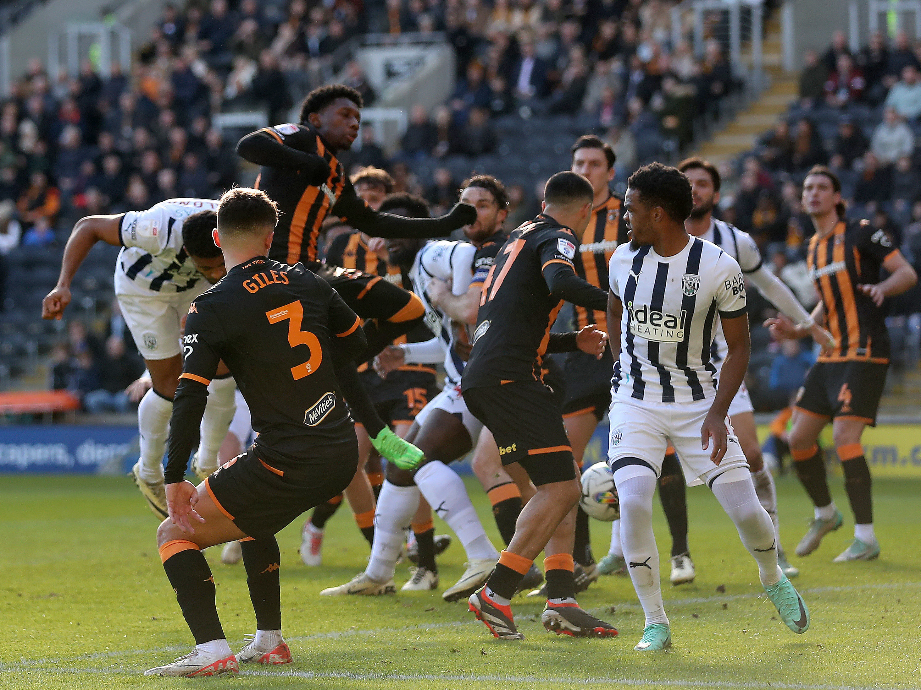 Albion players and Hull players battle for a ball in the air in the box 