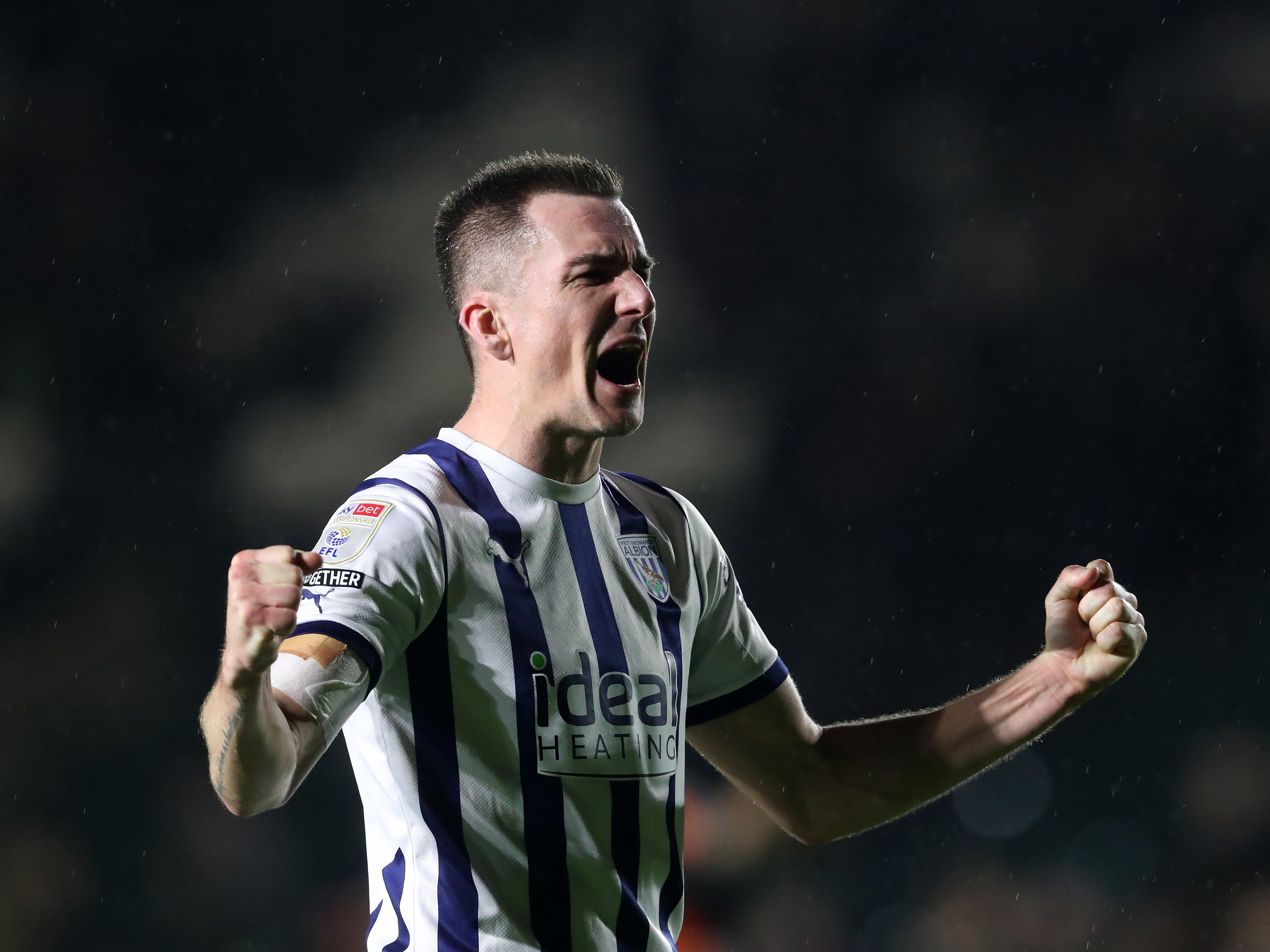 Jed Wallace celebrating towards Albion fans after winning at Plymouth