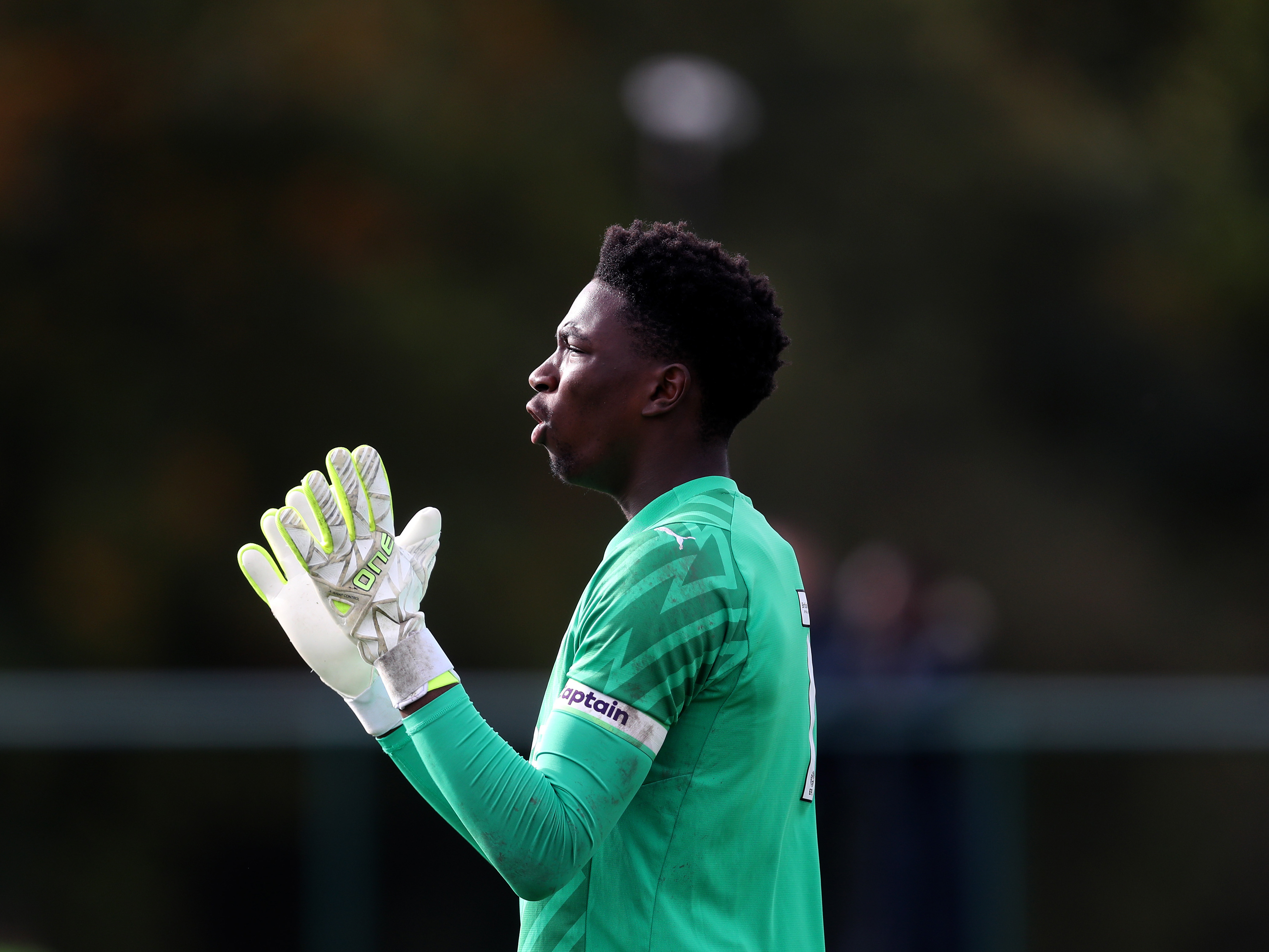 A photo of Albion academy goalkeeper Ben Cisse shouting commands during a PL2 game at a sunny club training ground