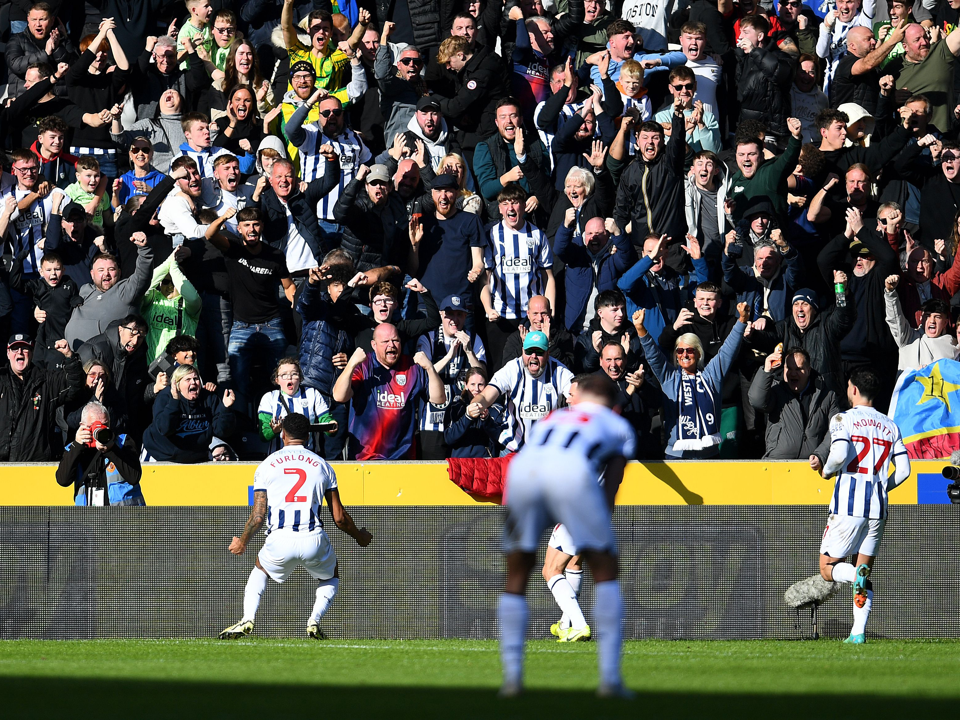 An image of Darnell Furlong celebrating with Albion's supporters
