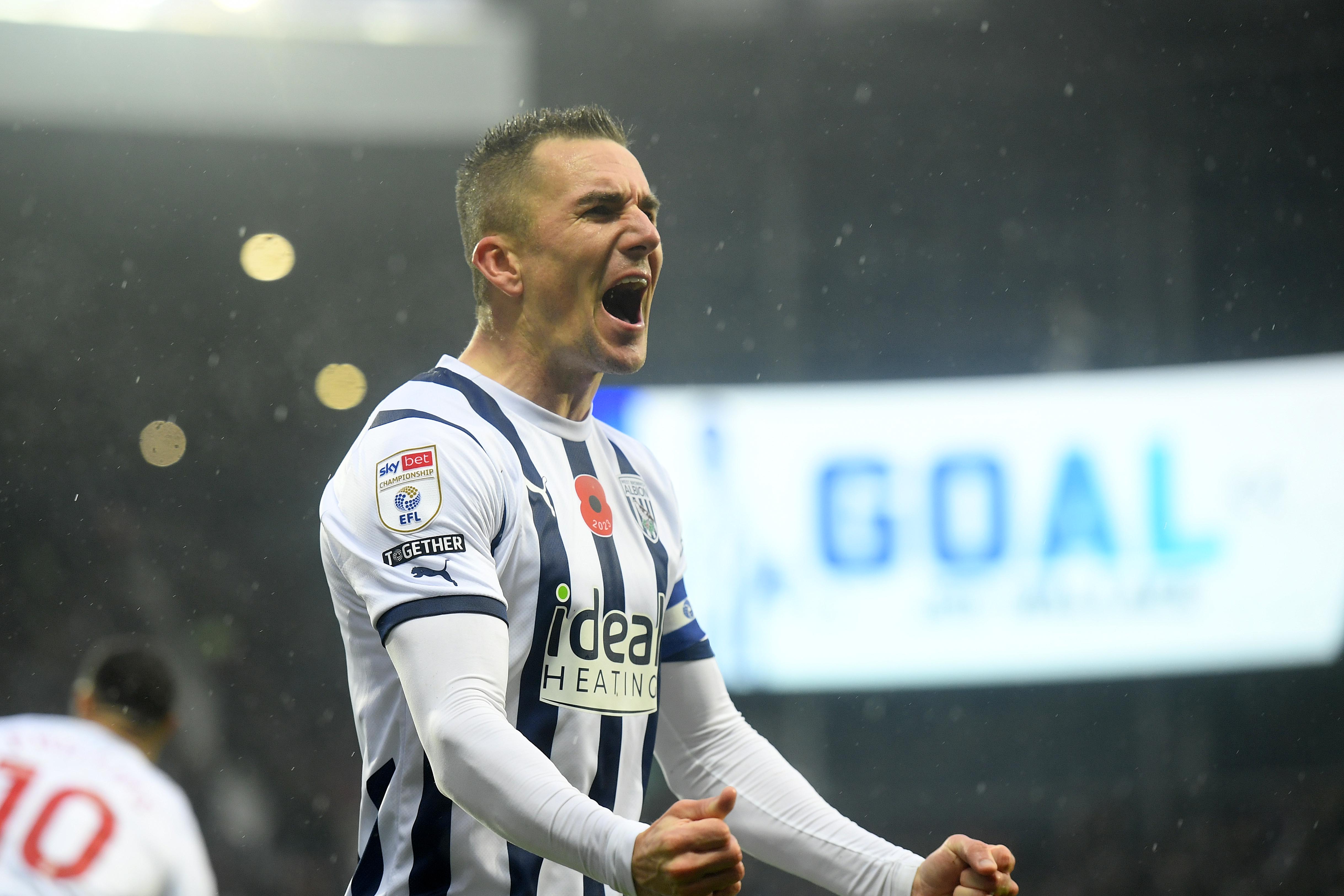 Jed Wallace celebrates scoring against Hull City at The Hawthorns with goal written on the big screen in the background 