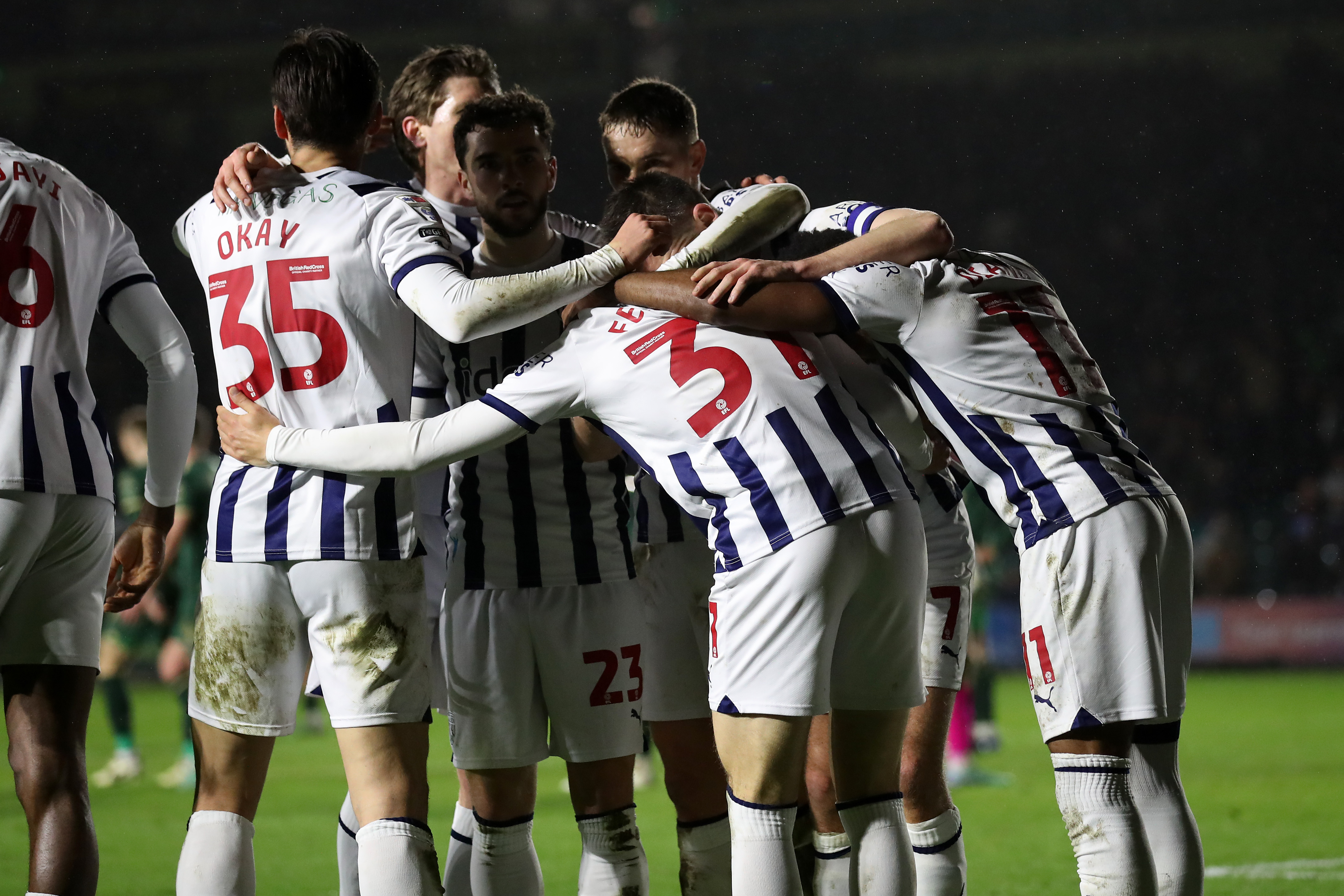 Albion players in a huddle celebrate after scoring a goal at Plymouth 