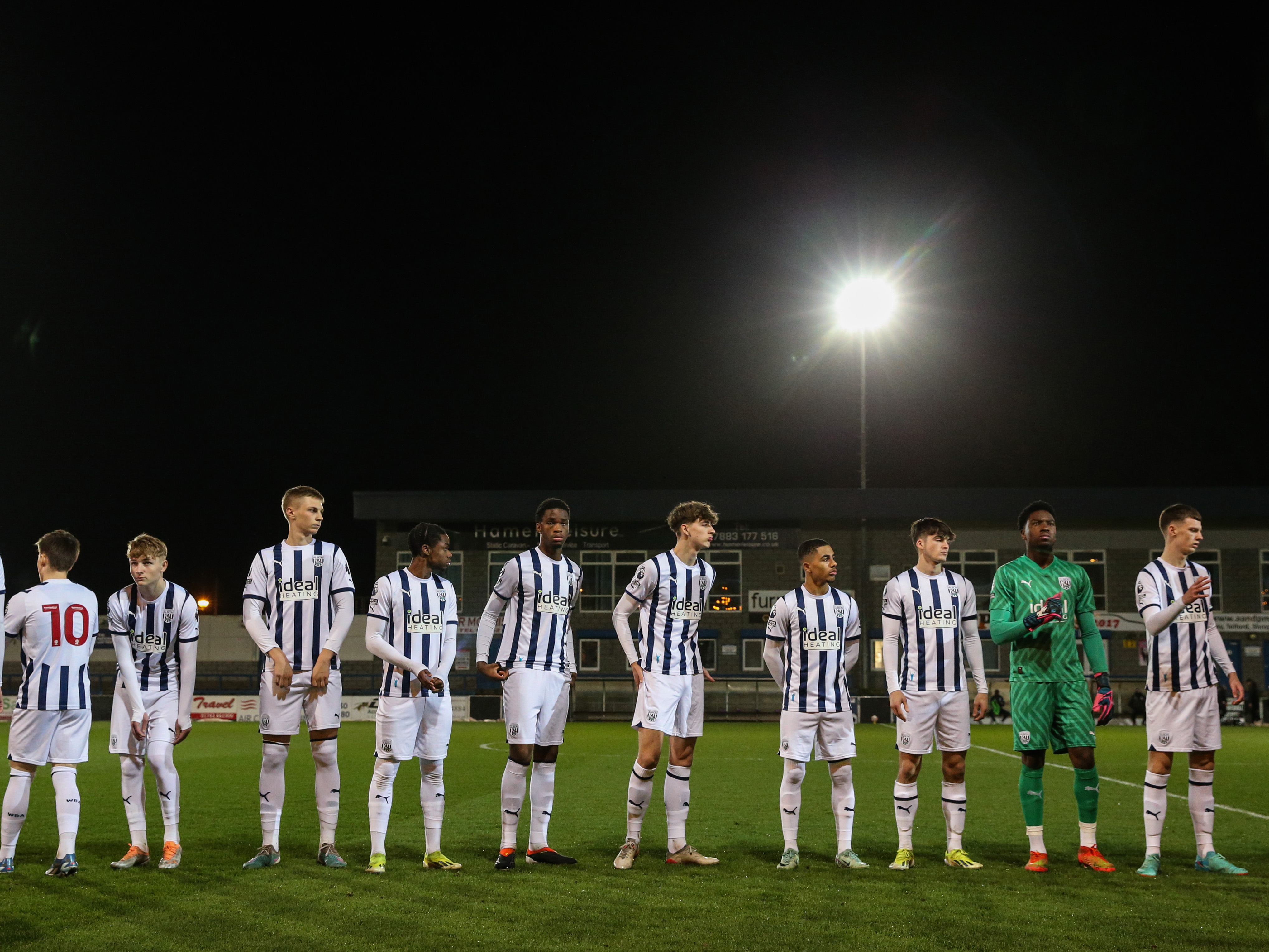 A photo of Albion's U21s lining up under the lights at AFC Telford's New Bucks Head ground