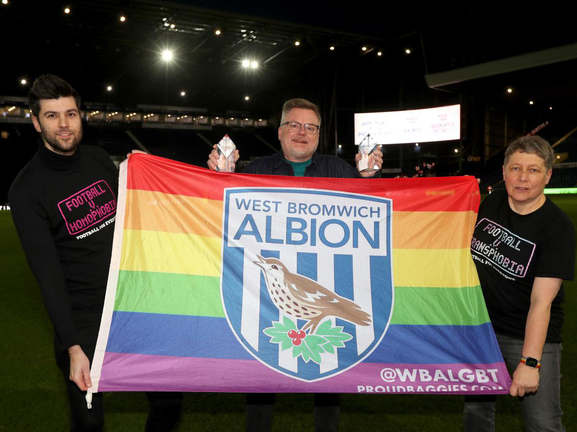 Proud Baggies members holding up an Albion rainbow flag at The Hawthorns