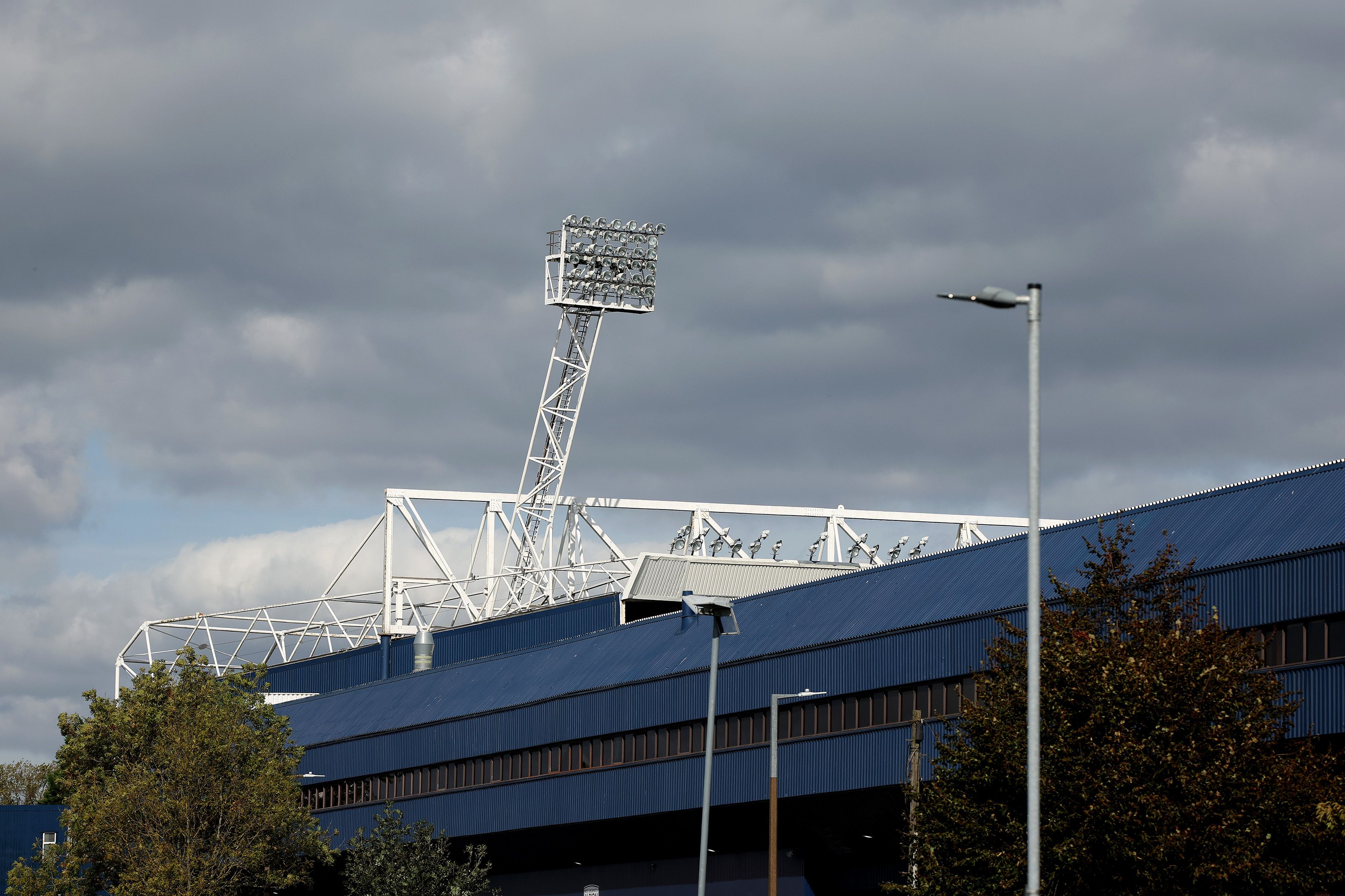 A view of a floodlight at The Hawthorns with a grey sky above