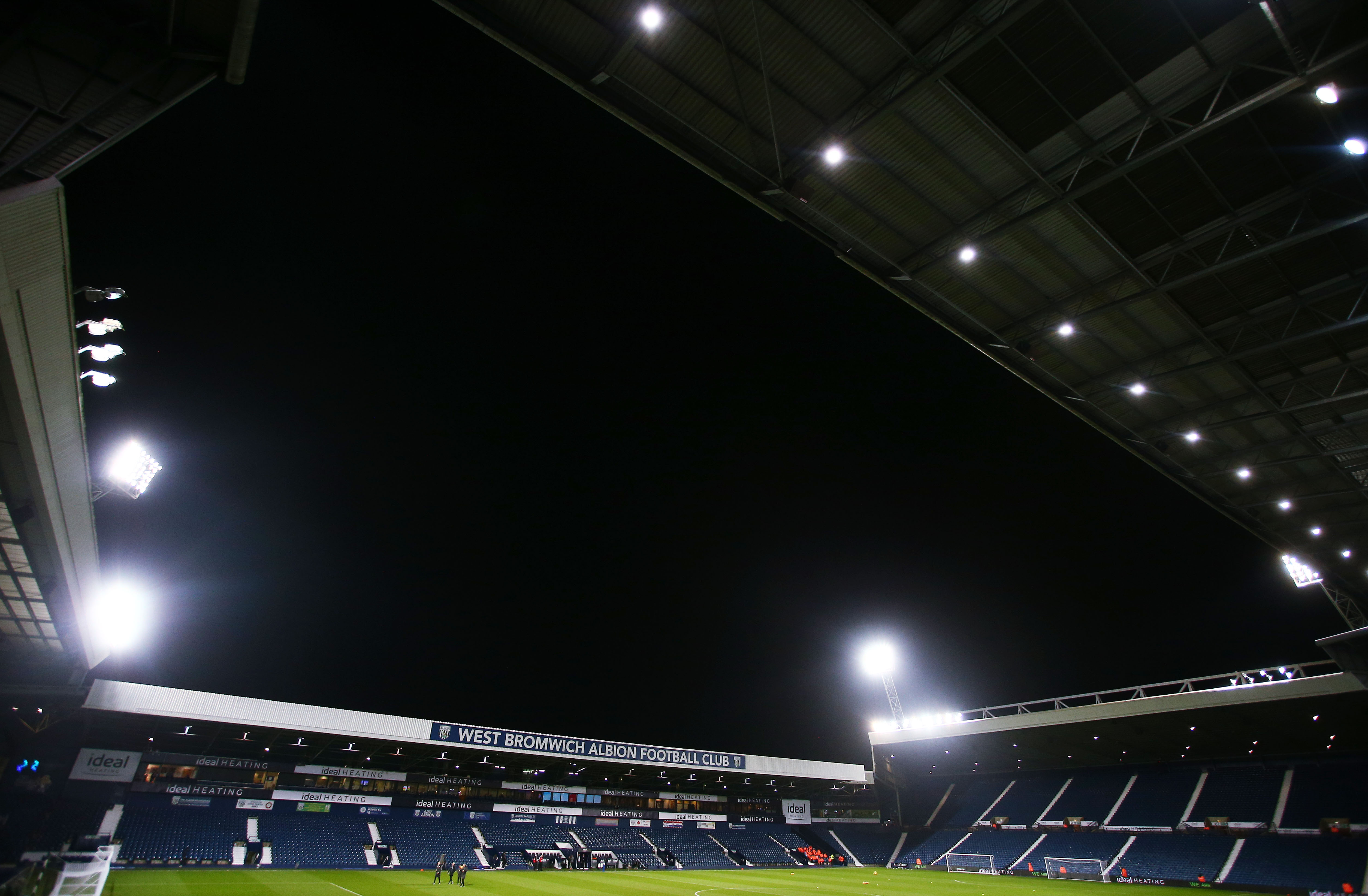 A general view of the West Stand and the Brummie Road End at The Hawthorns under a night sky and floodlights