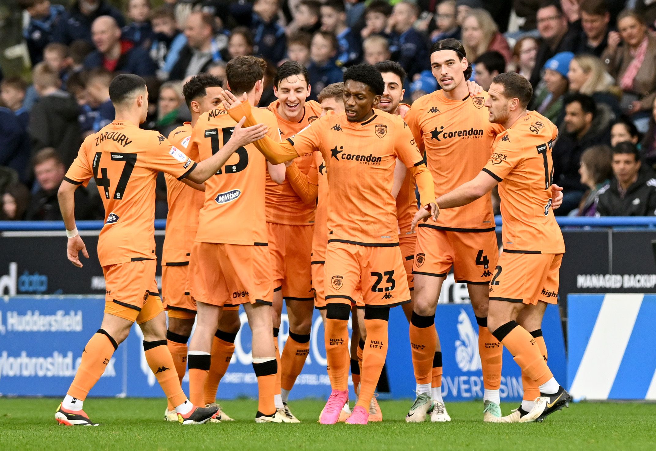 Hull City players celebrate after scoring a goal against Huddersfield 