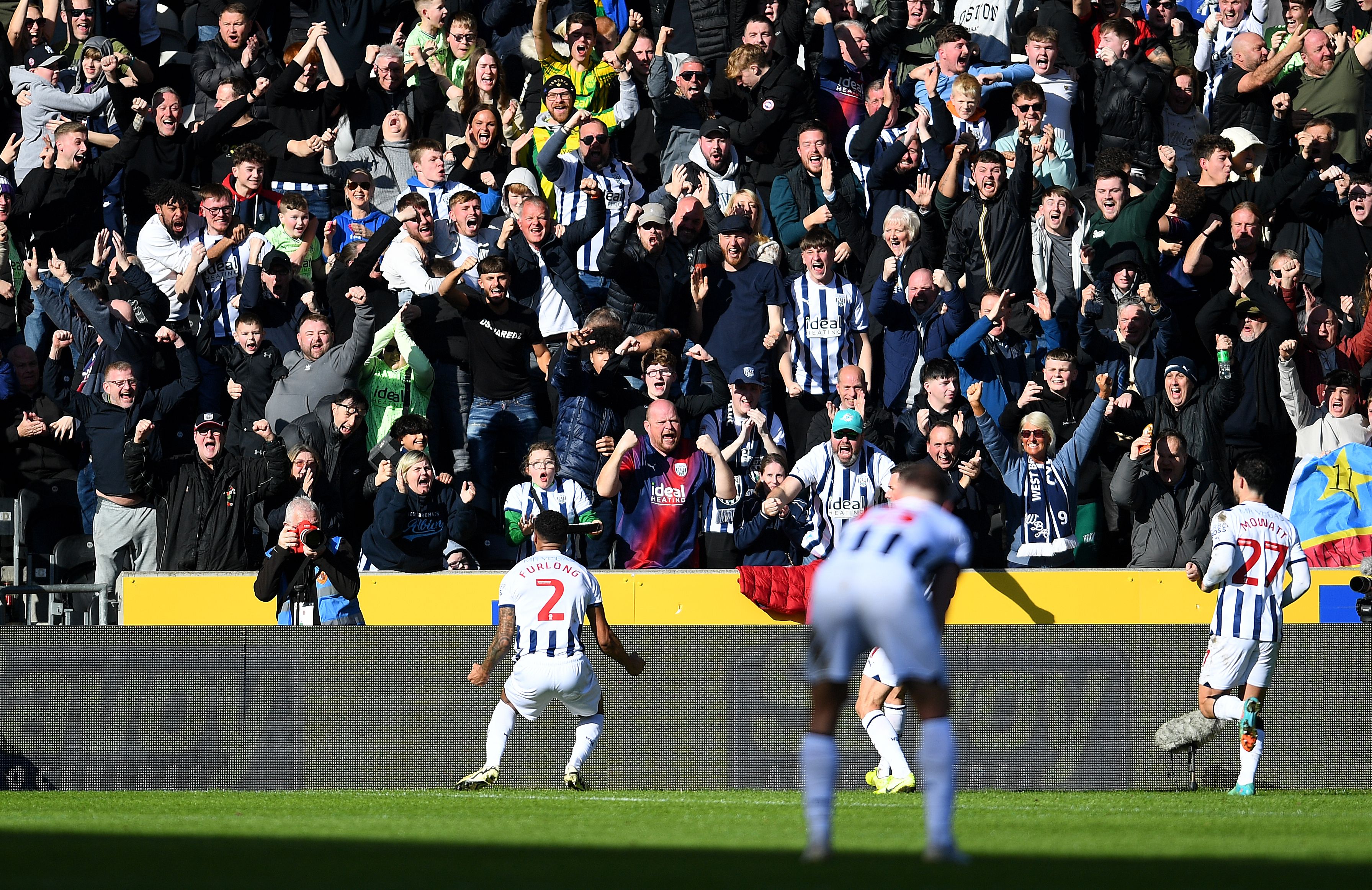 Darnell Furlong celebrates his goal against Hull with Albion fans in front of him