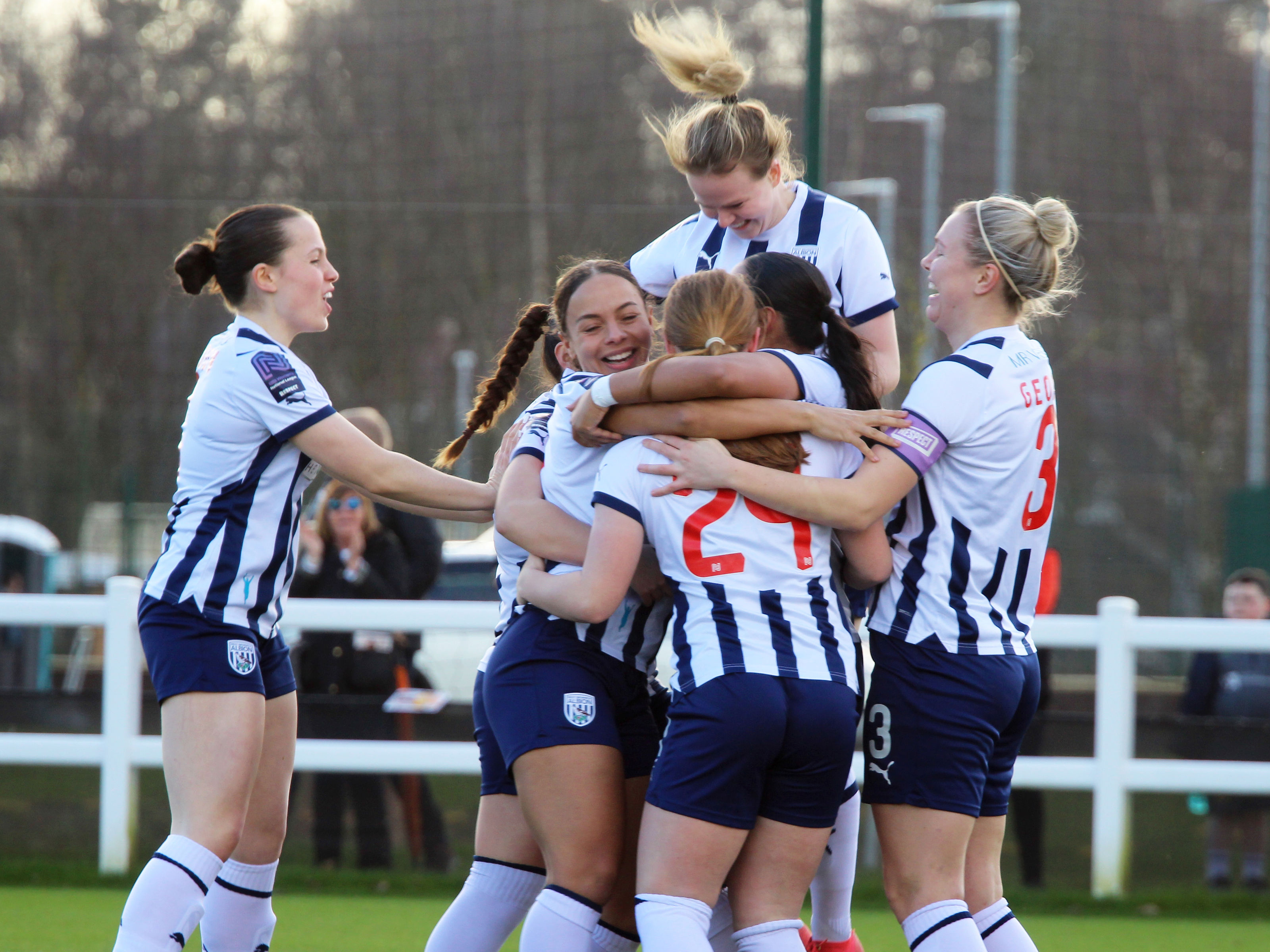 An image of Albion Women celebrating a goal against Wolves