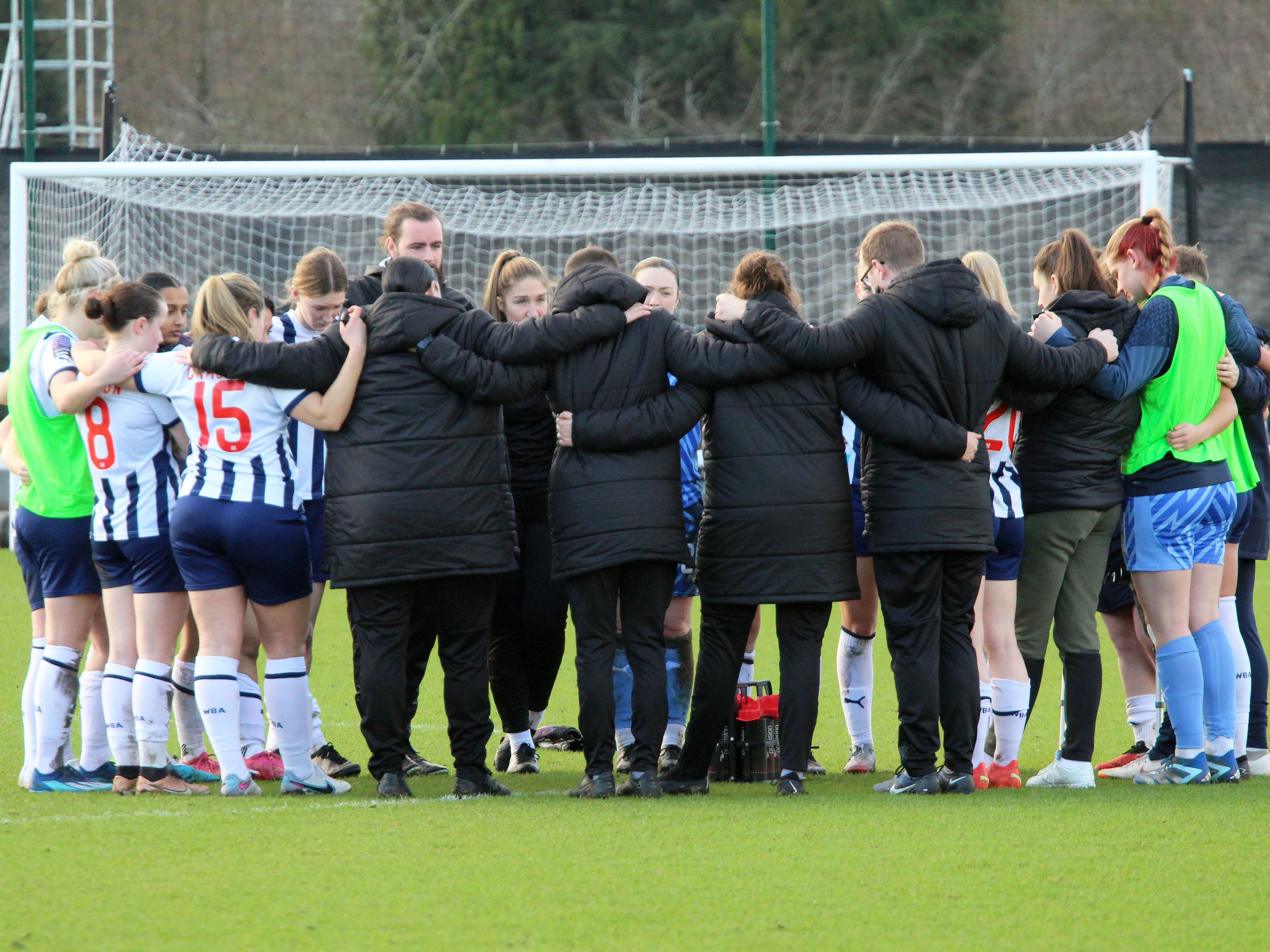 An image of the Albion Women team in a huddle