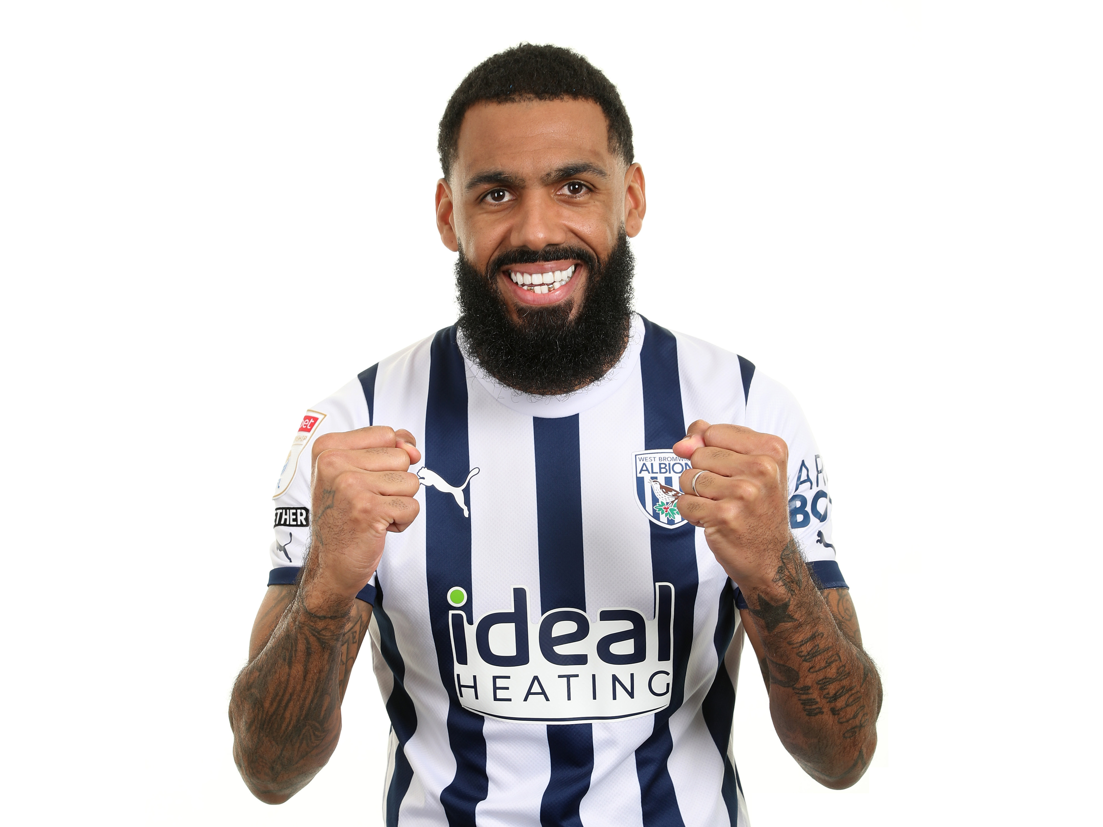 Yann M'Vila in a home shirt smiling at the camera