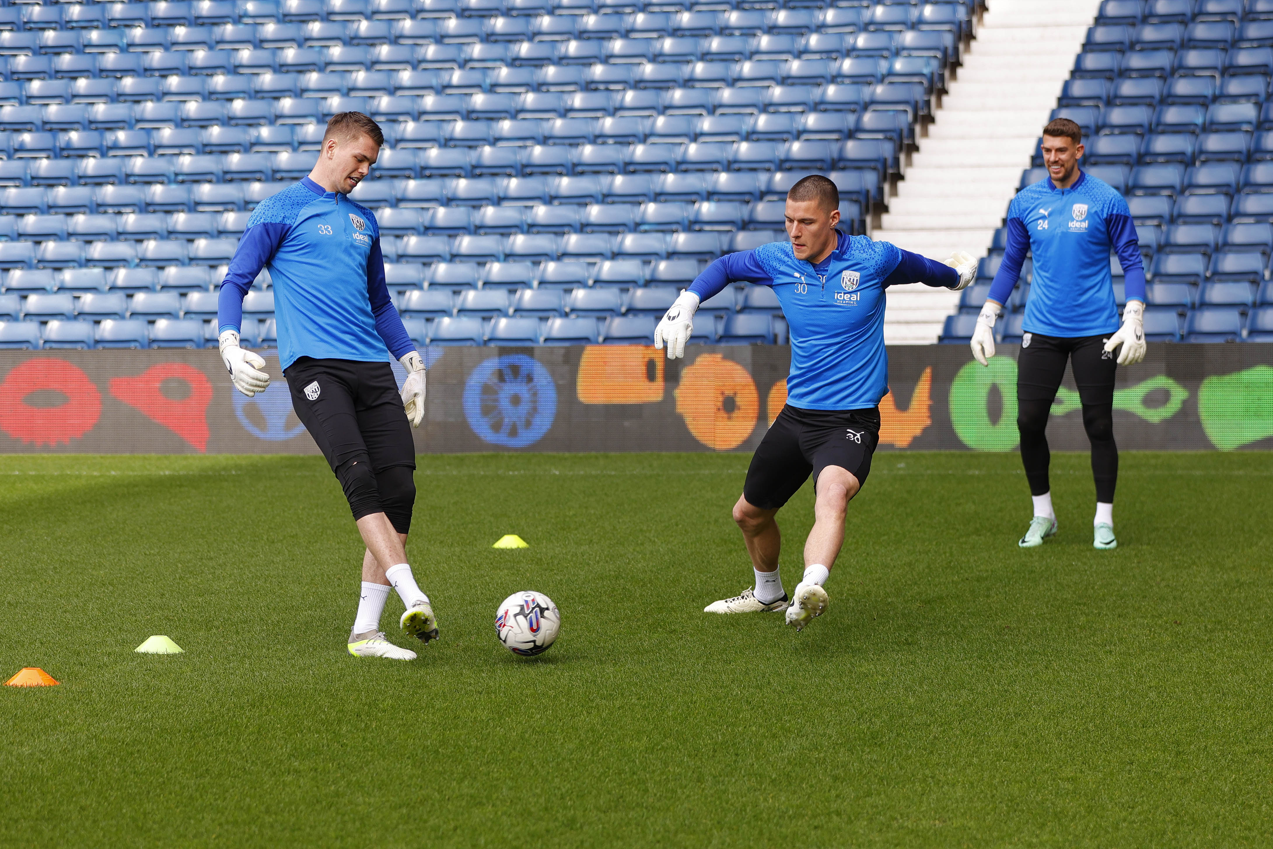 Albion goalkeepers playing a passing game on the pitch at The Hawthorns during a training session