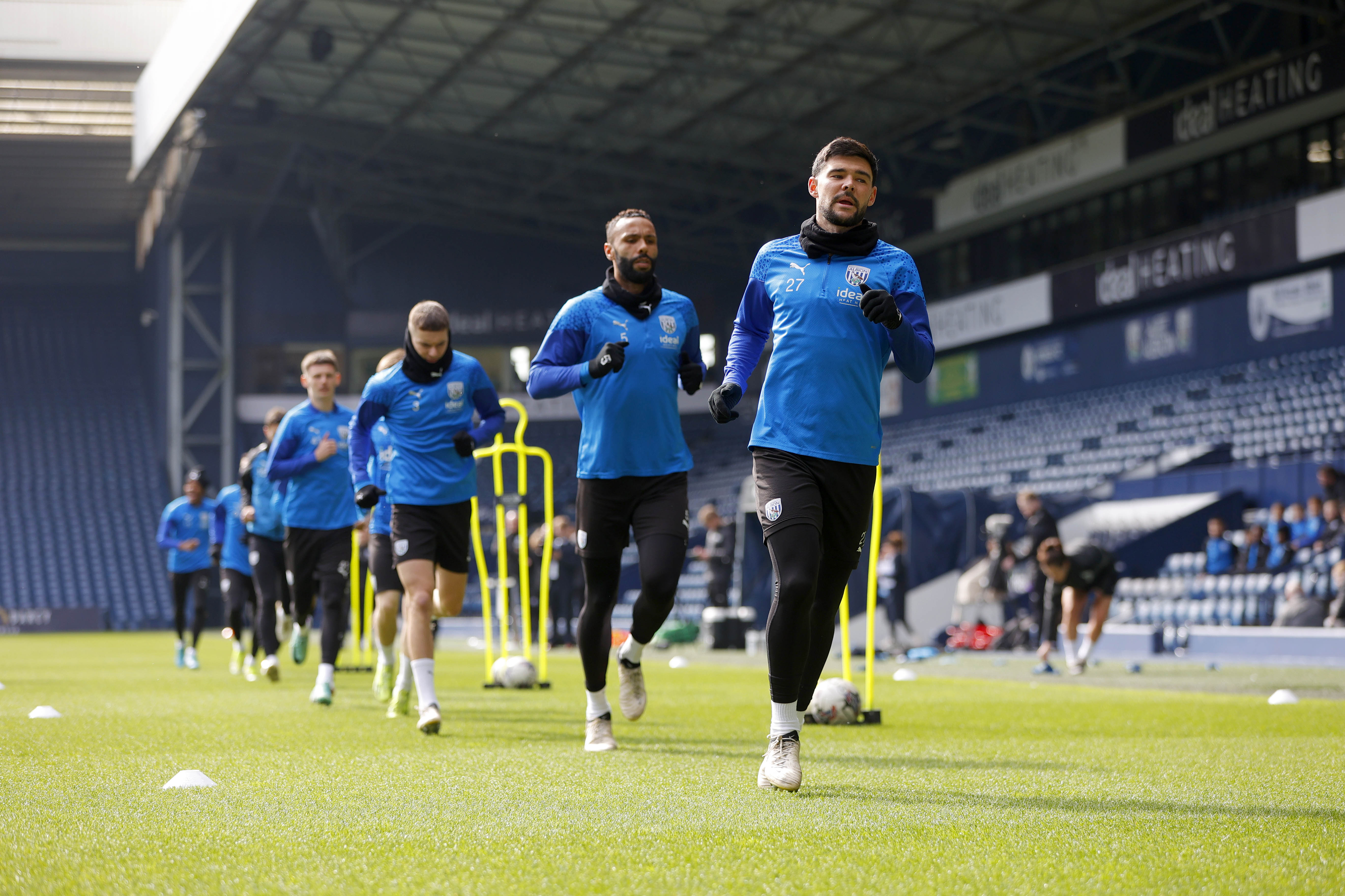 Albion players warming up on the pitch at The Hawthorns during a training session