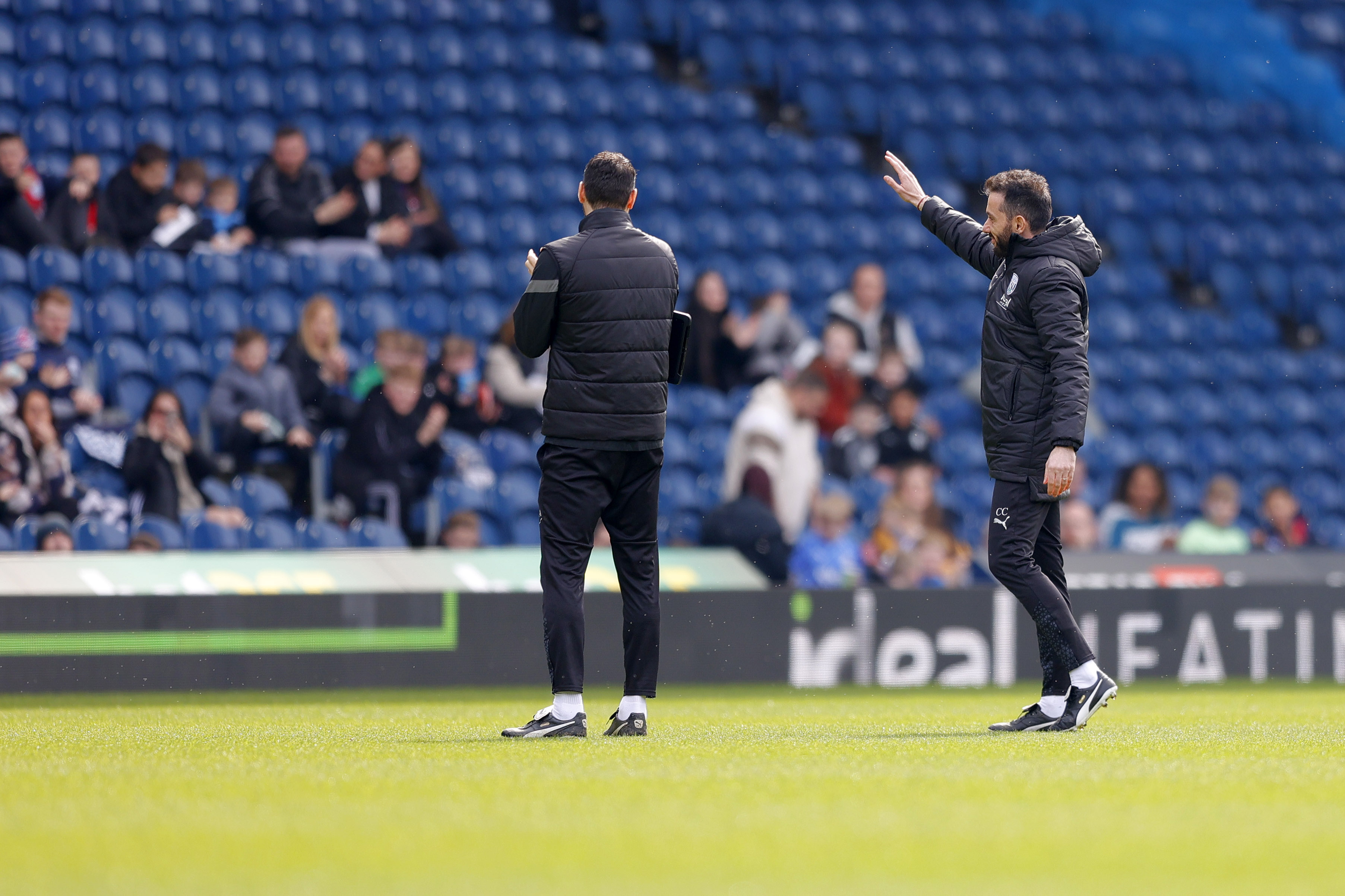 Carlos Corberán waving to supporters during a training session at The Hawthorns