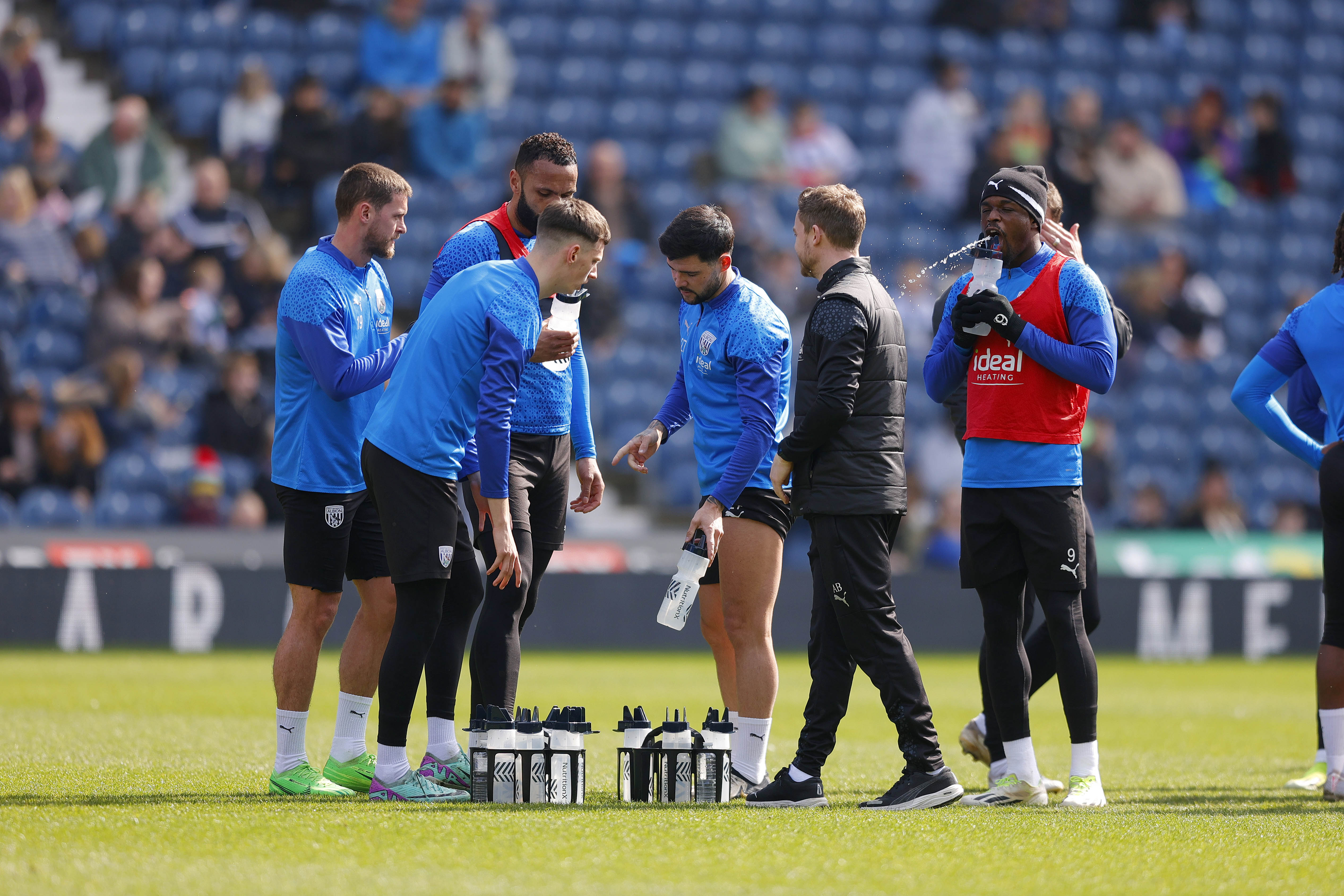 Albion players pause during a training session at The Hawthorns to take on some fluids 