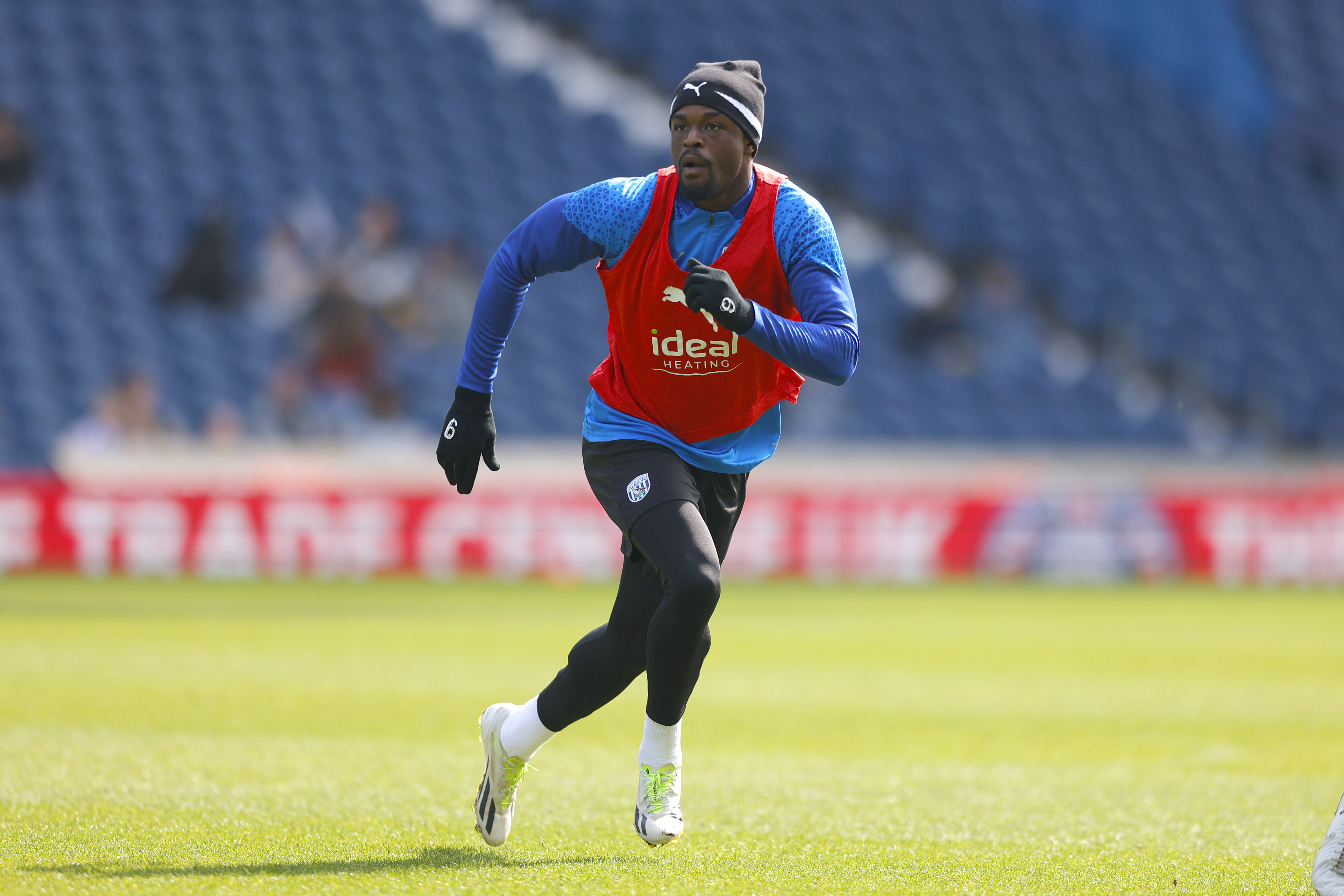 Josh Maja running forward watching the ball during a training session at The Hawthorns