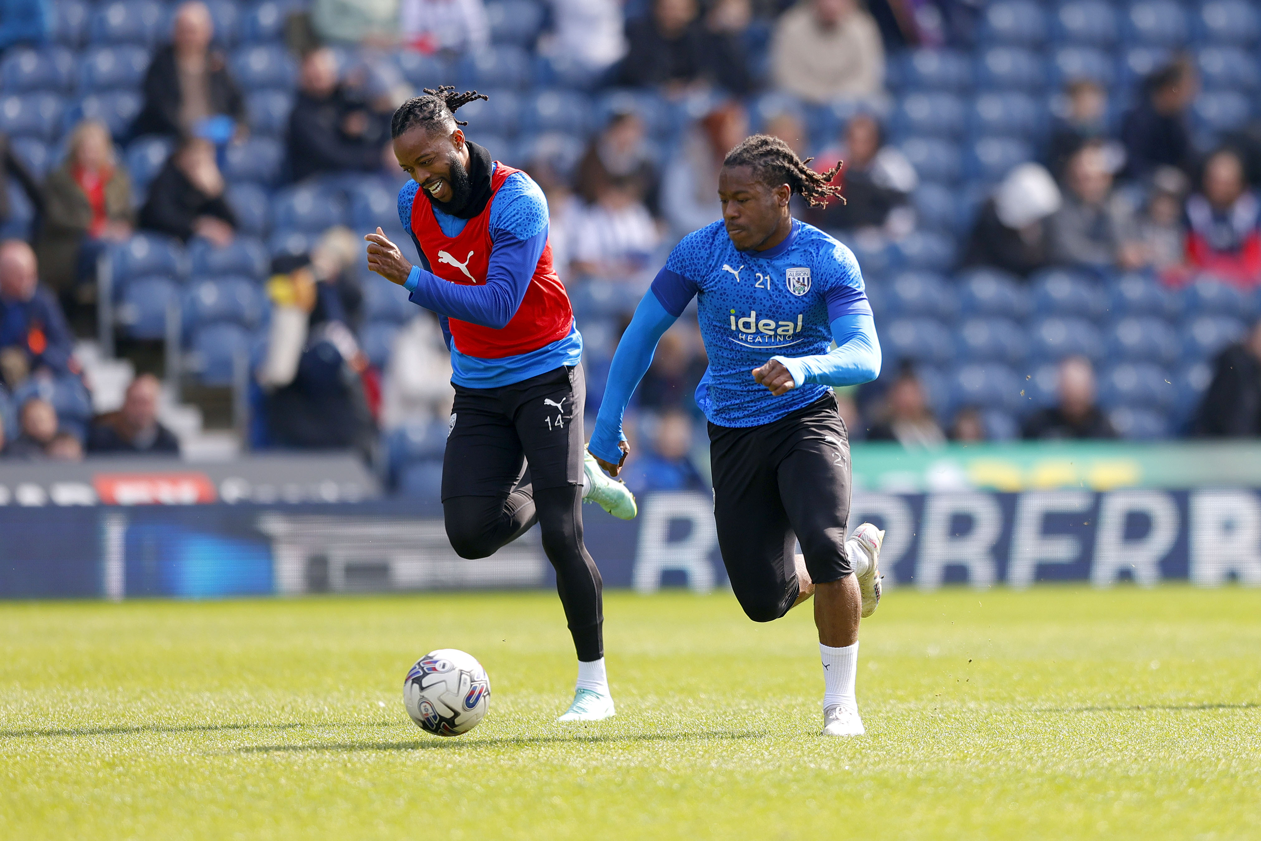 Brandon Thomas-Asante and Nathaniel Chalobah chasing after the ball during a training session at The Hawthorns