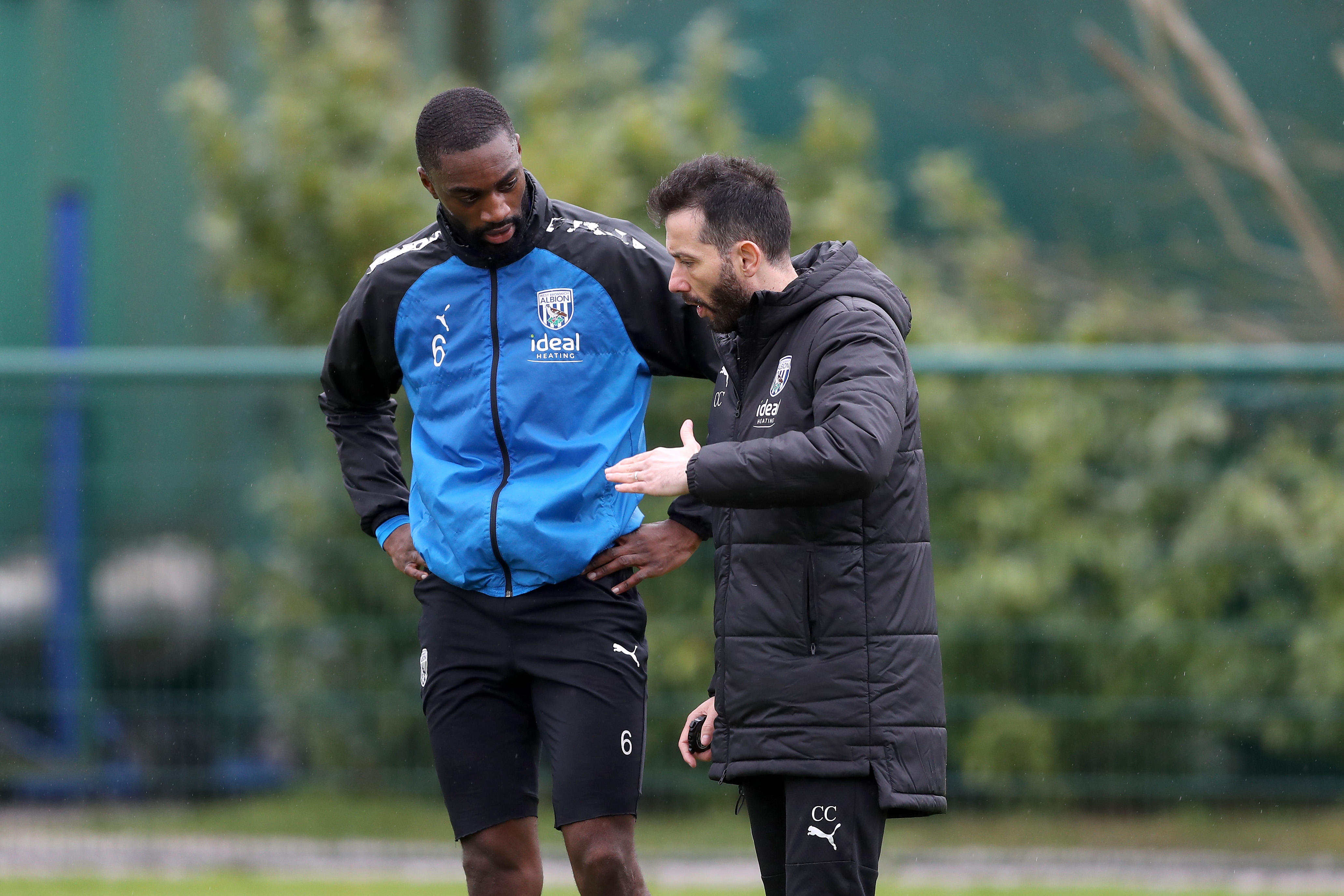 Carlos Corberán delivering information to Semi Ajayi out on the training pitches