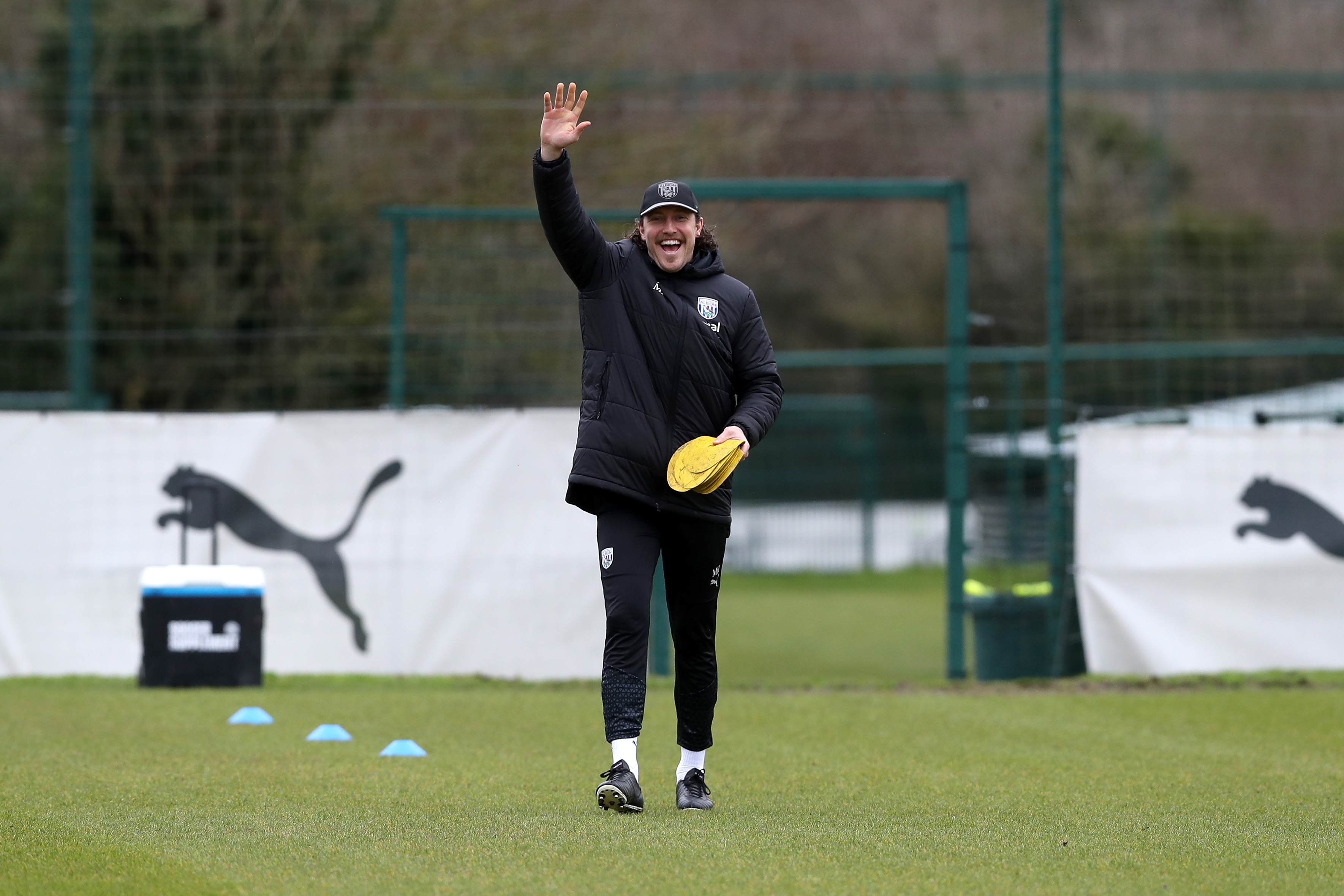 Michael Hefele waving at the camera while out on the training pitch