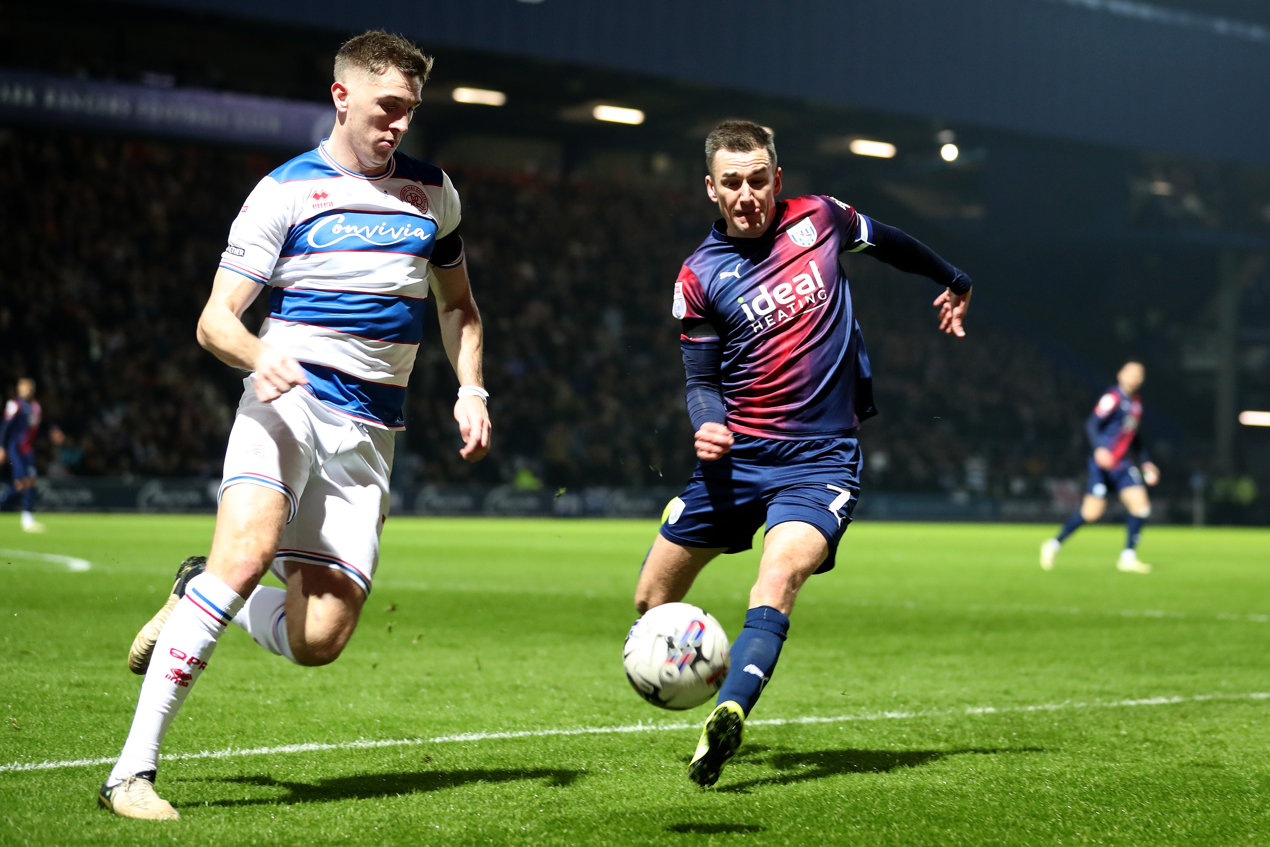 Jed Wallace chasing down the ball and a QPR player 