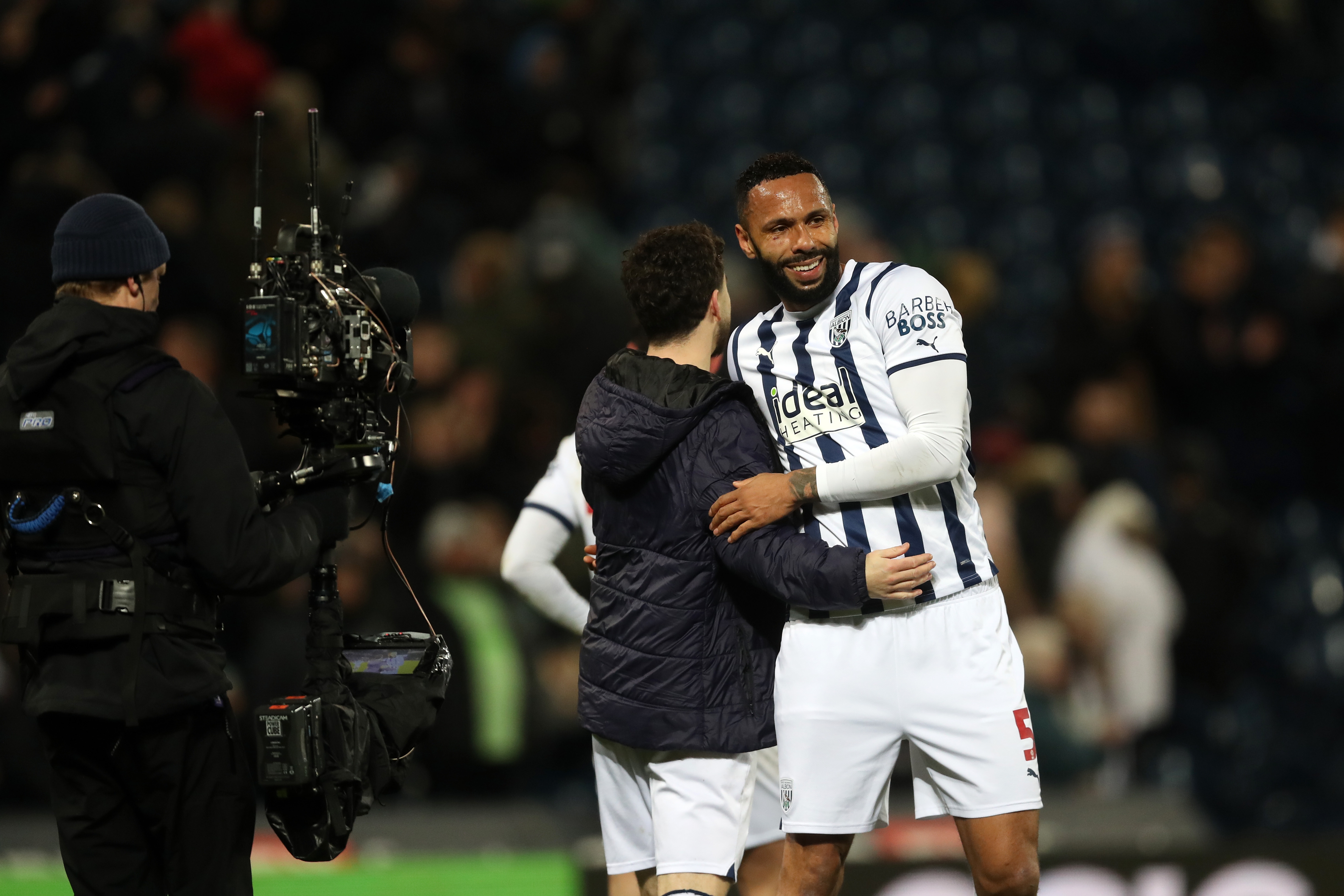 Mikey Johnston and Kyle Bartley embrace after beating Coventry 
