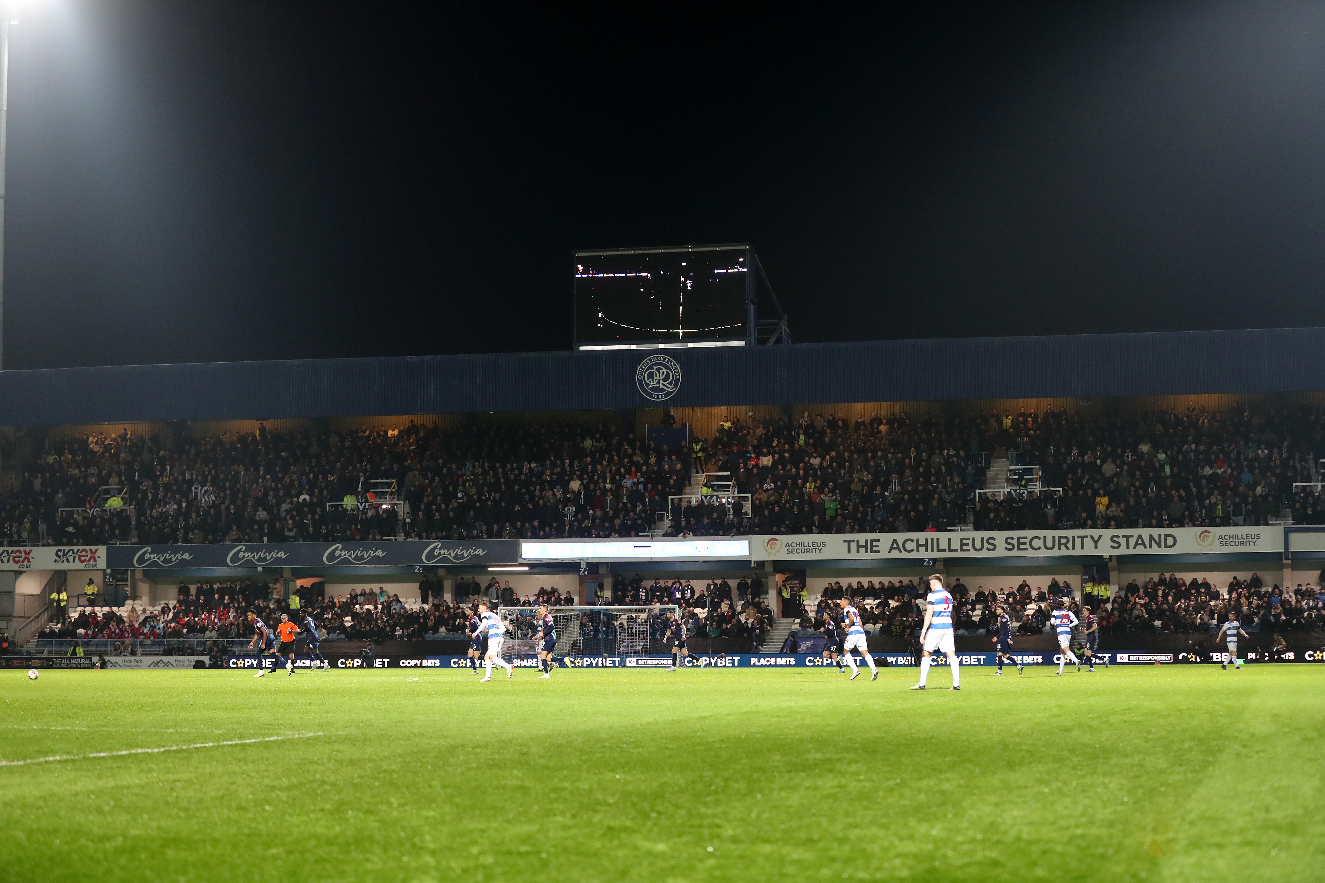 A general view of Albion fans in the top tier of the stand behind the goal at Loftus Road 