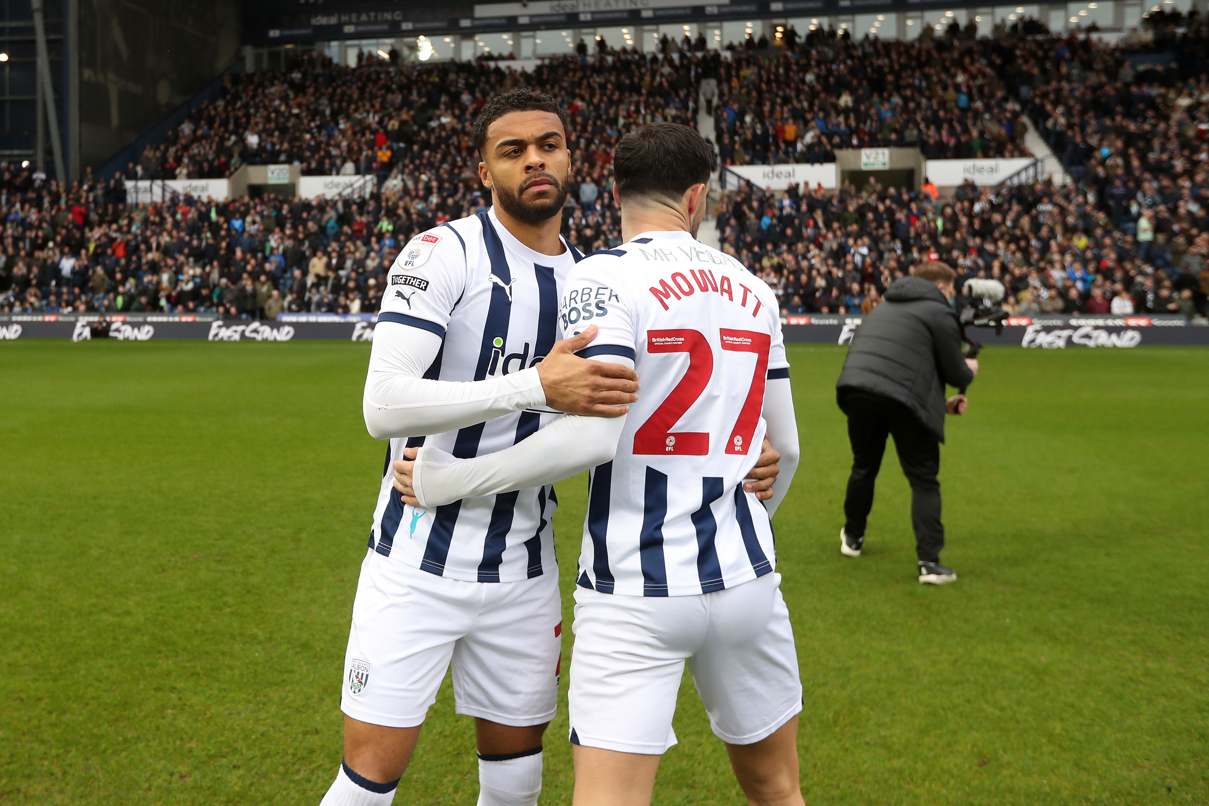 Alex Mowatt and Darnell Furlong embrace on the pitch before the game against Bristol City