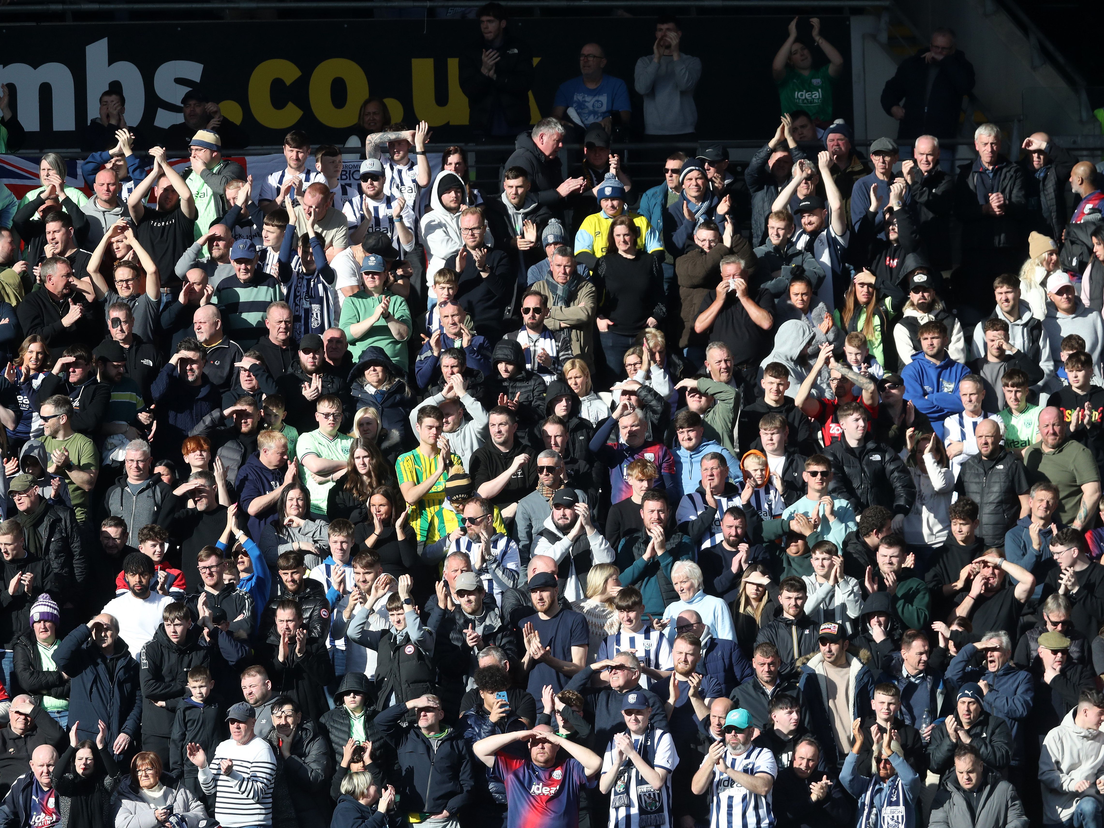 An image of Albion supporters applauding their team