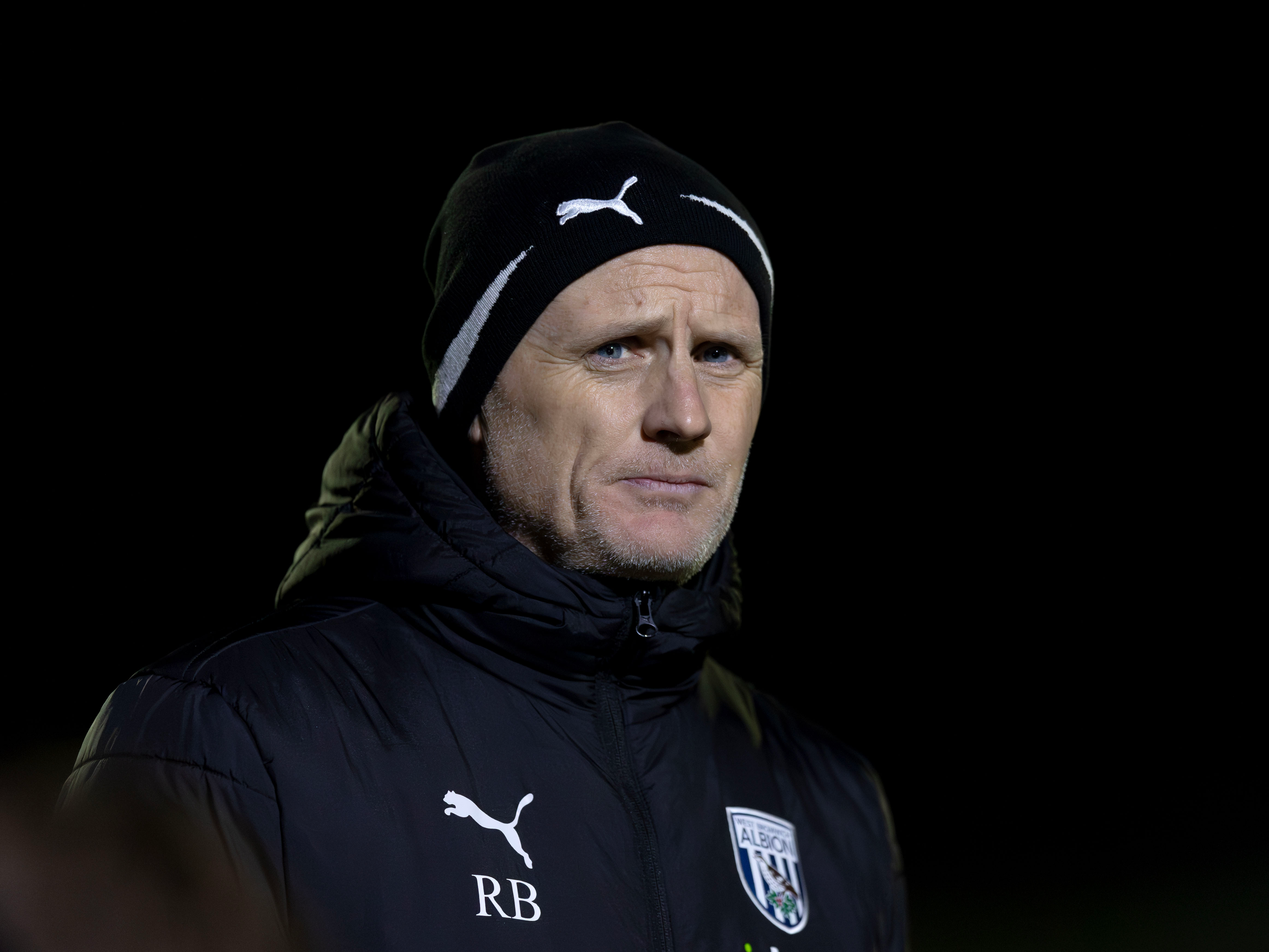 A photo of U21s boss Richard Beale in a black Albion crested coat