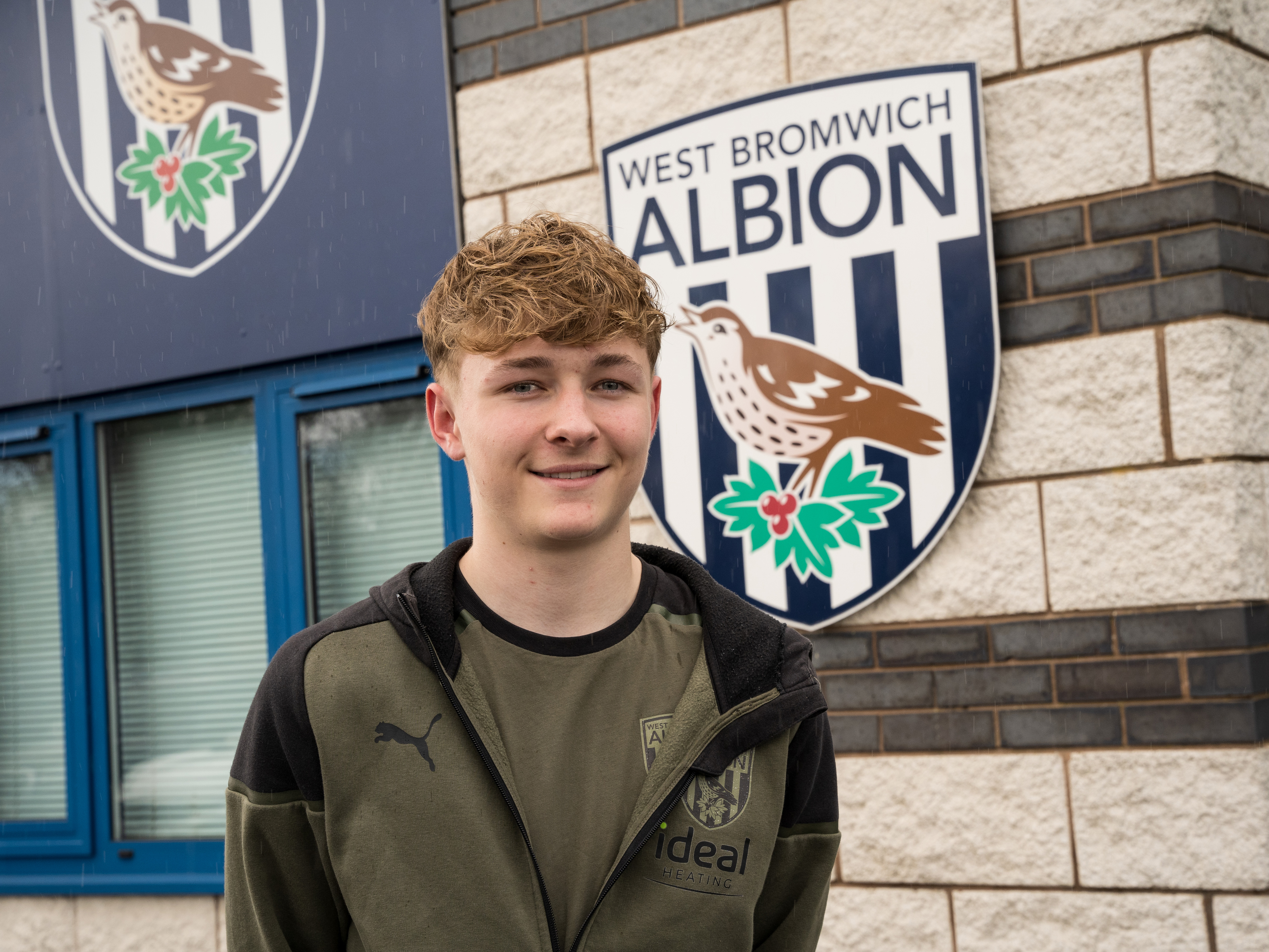 A photo of Albion youngster Ollie Bostock in front of the Albion Training Ground