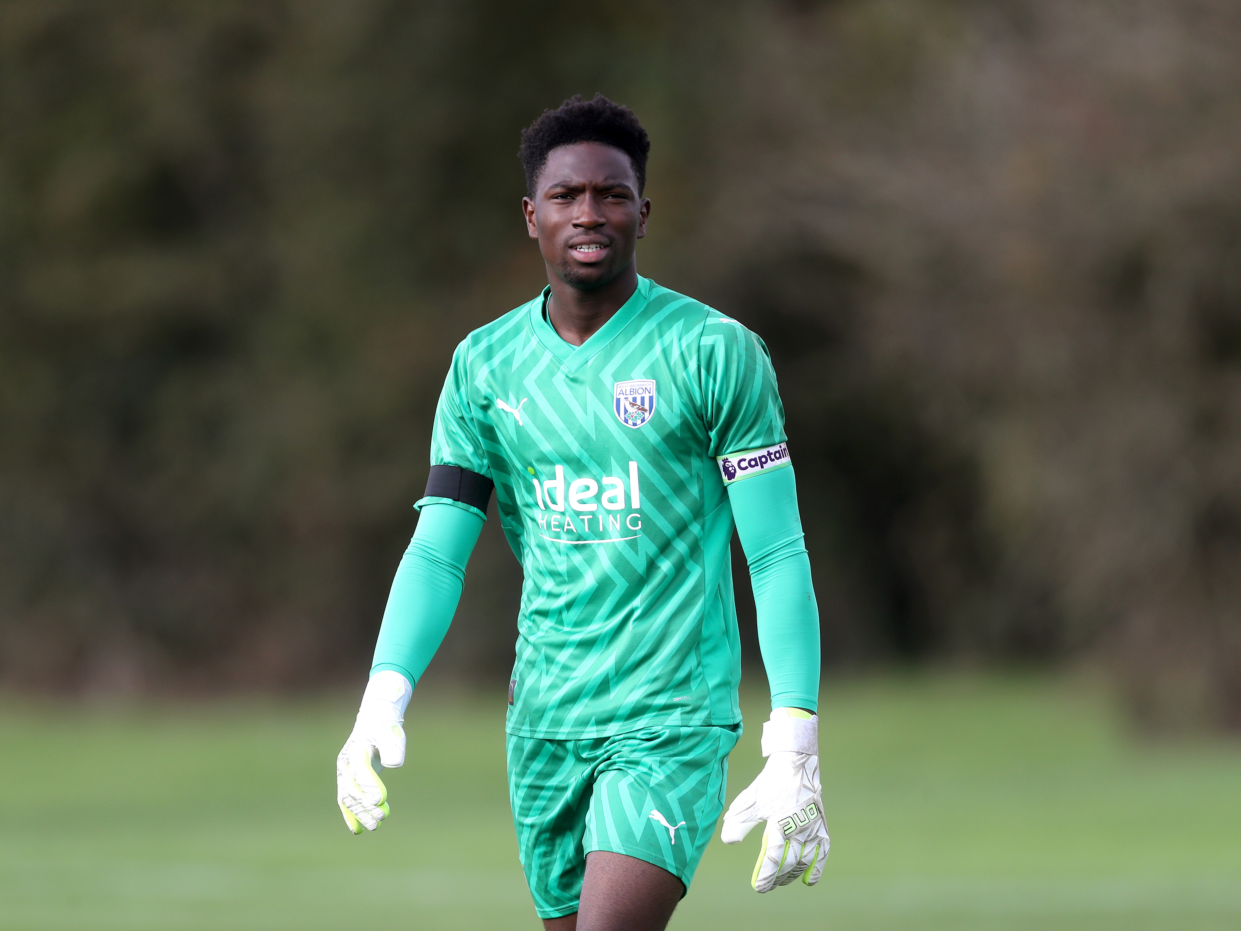 A photo of youngster Ben Cisse, wearing the 23/24 green keeper kit during a game at Albion's training ground