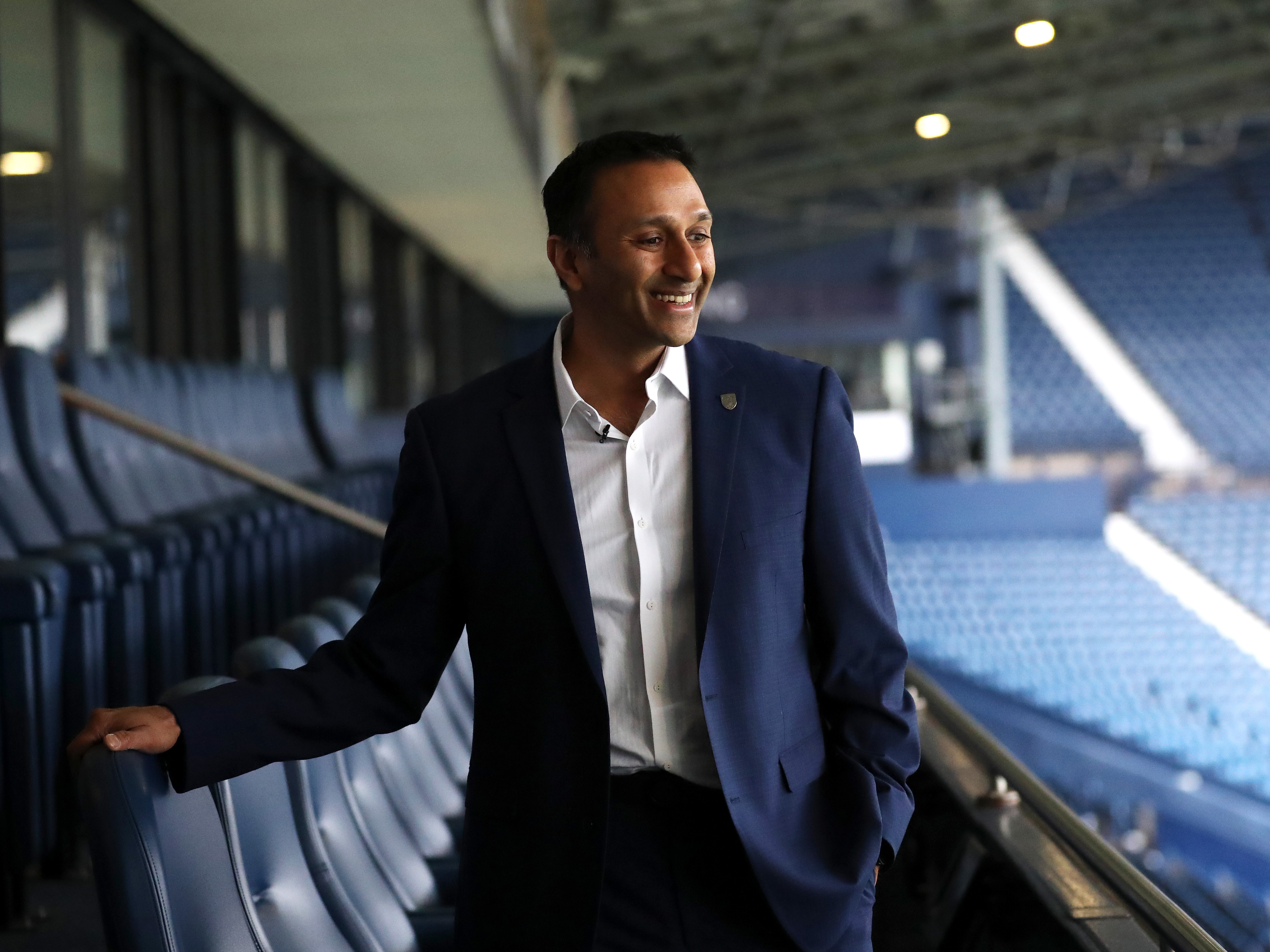 Shilen Patel smiling while stood on the balcony at The Hawthorns looking out on to the pitch