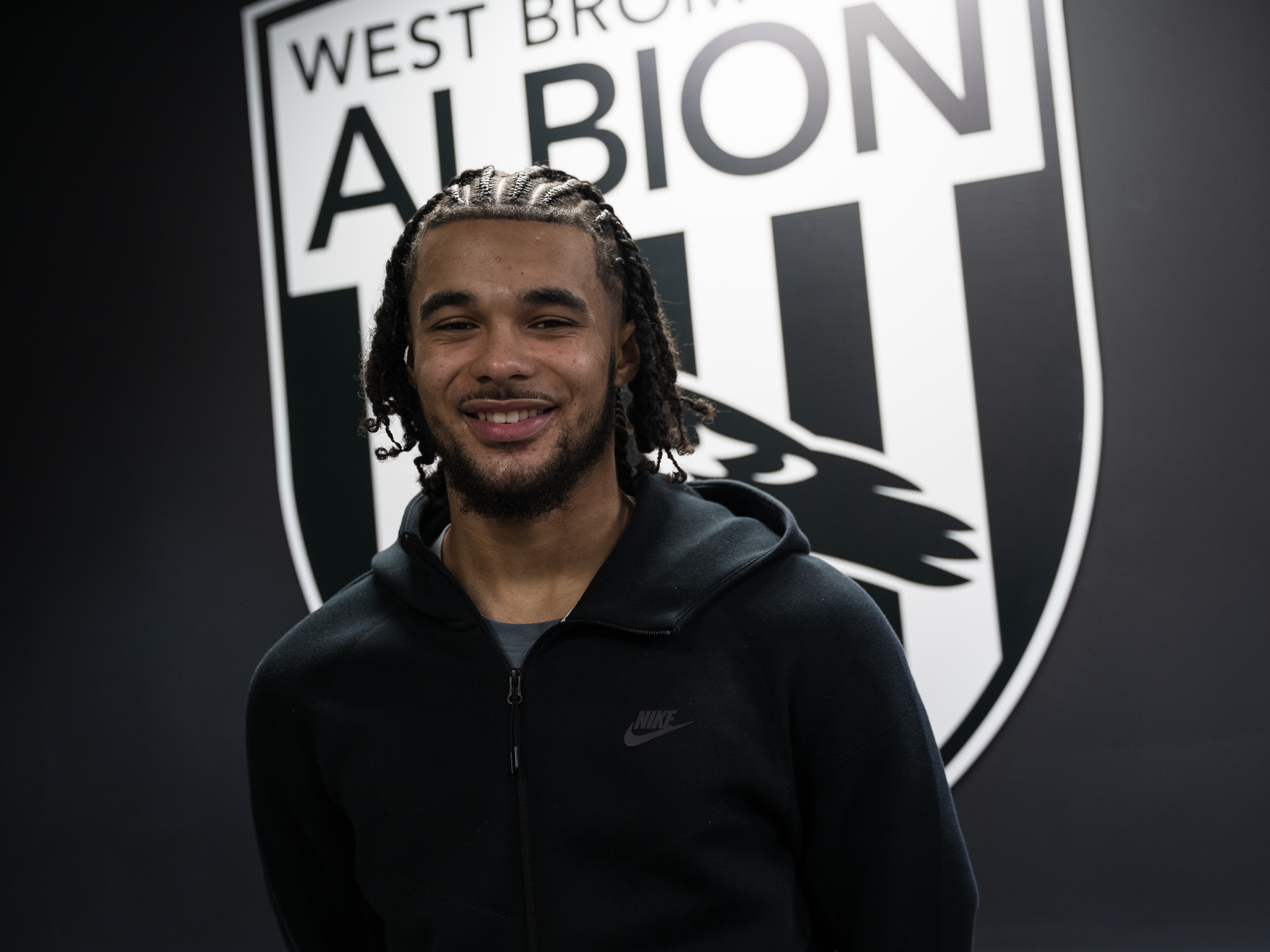 A photo of Jamal Mohammed in front of the Albion badge