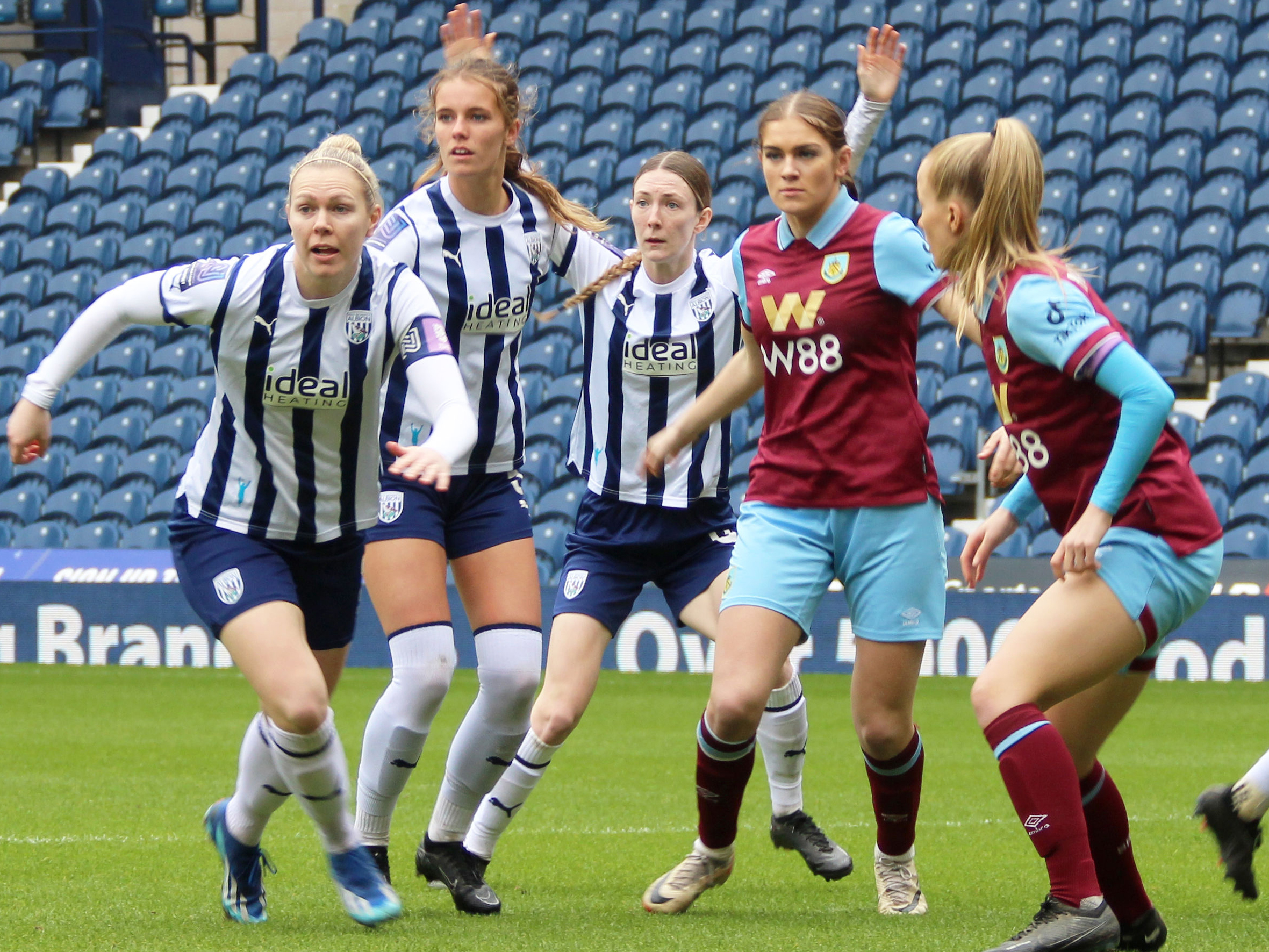 An image of Albion Women players Hannah George, Lucy Newell and Jess Reavill in action against Burnley