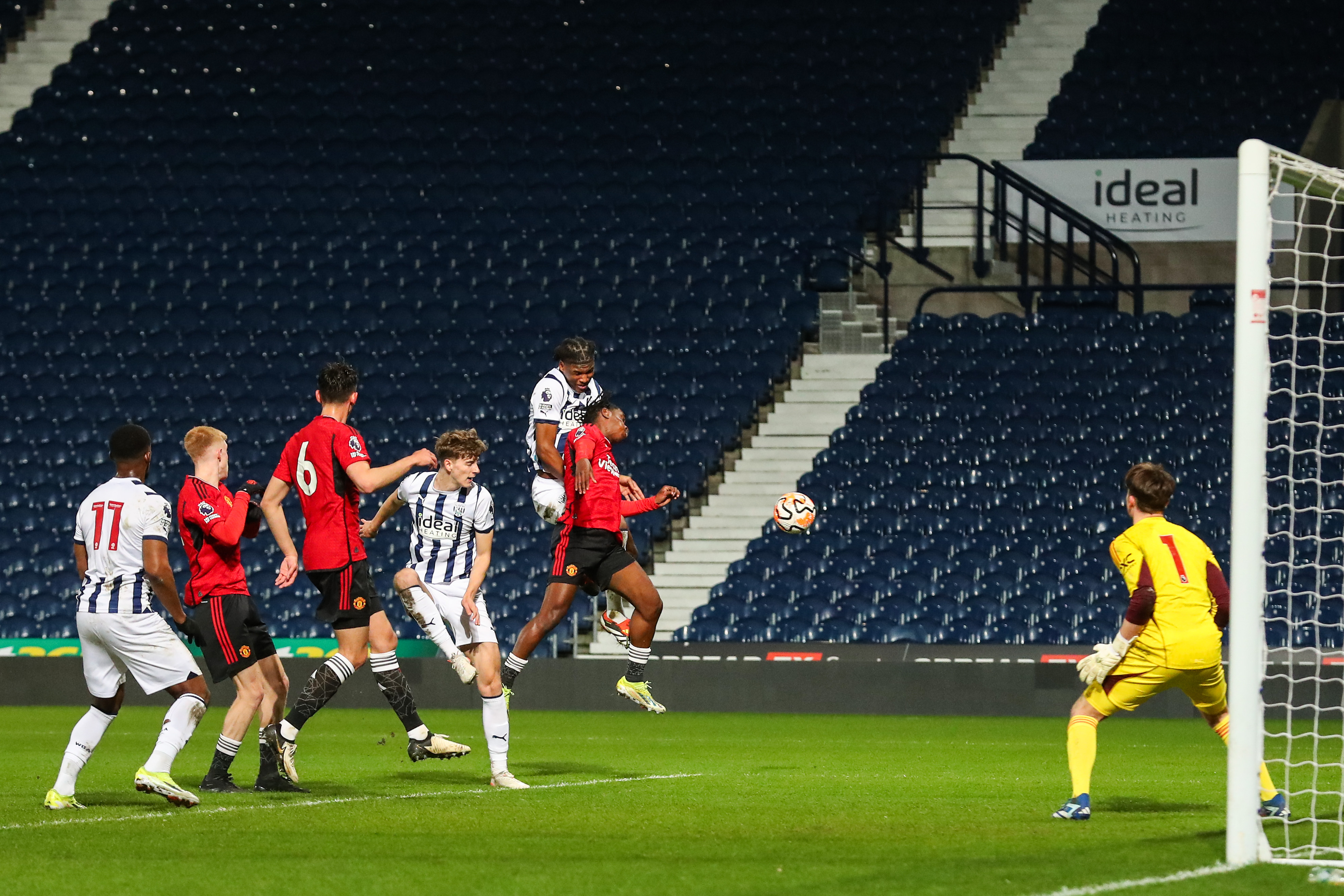 Several Albion and Man United PL2 players jump for the ball in the box as a cross is delivered 
