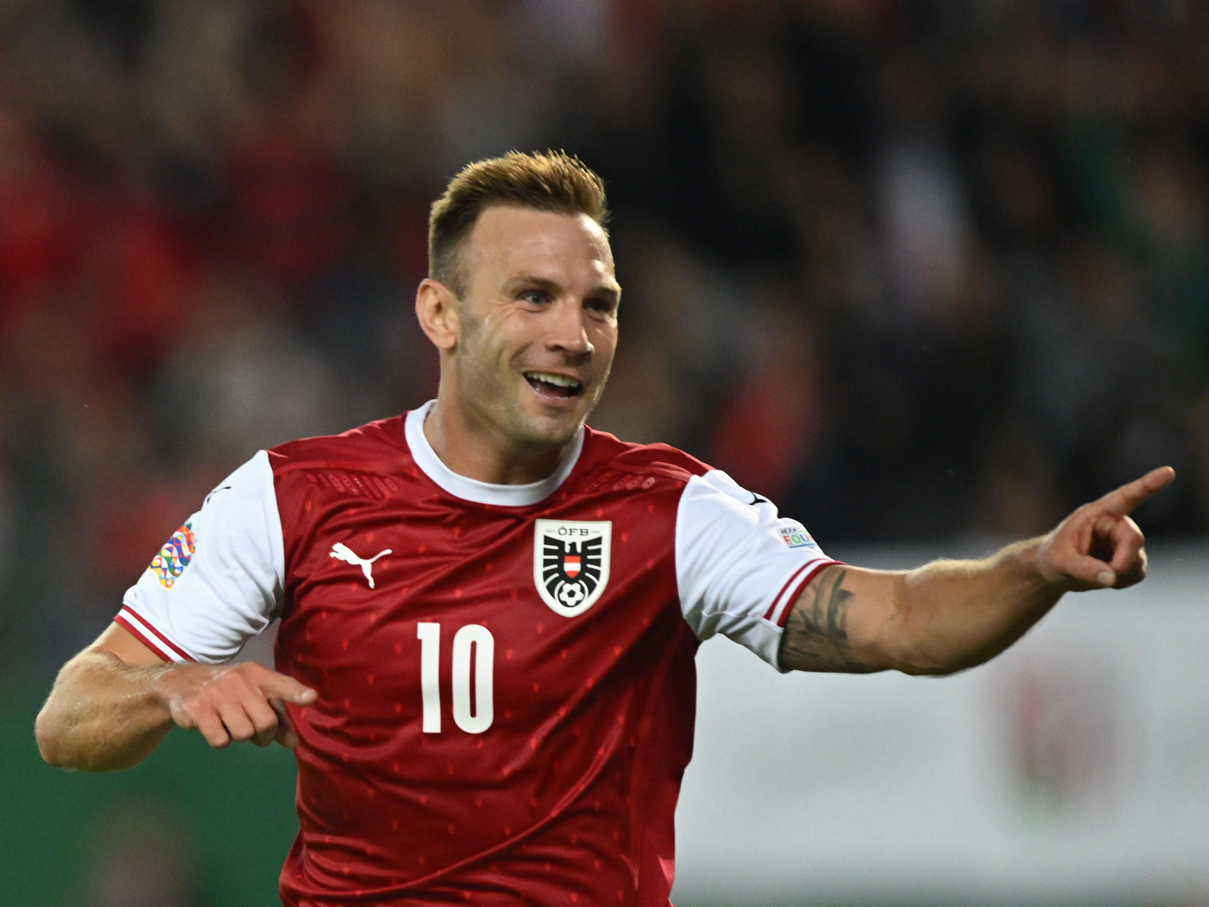 Andi Weimann celebrating a goal he scored for Austria in their national kit