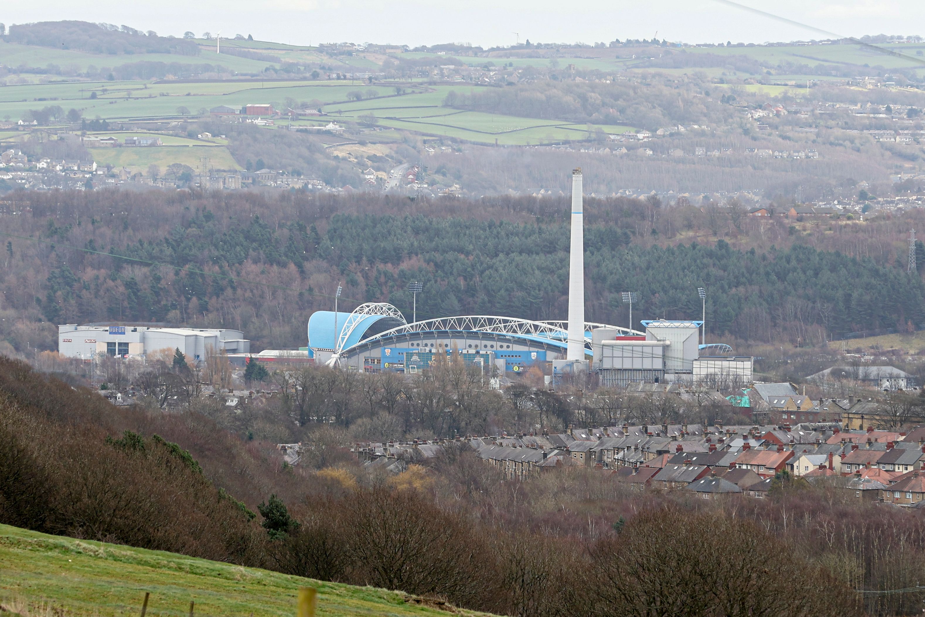 a general view of the John Smith's Stadium from a distance with the Yorkshire hills in the background 